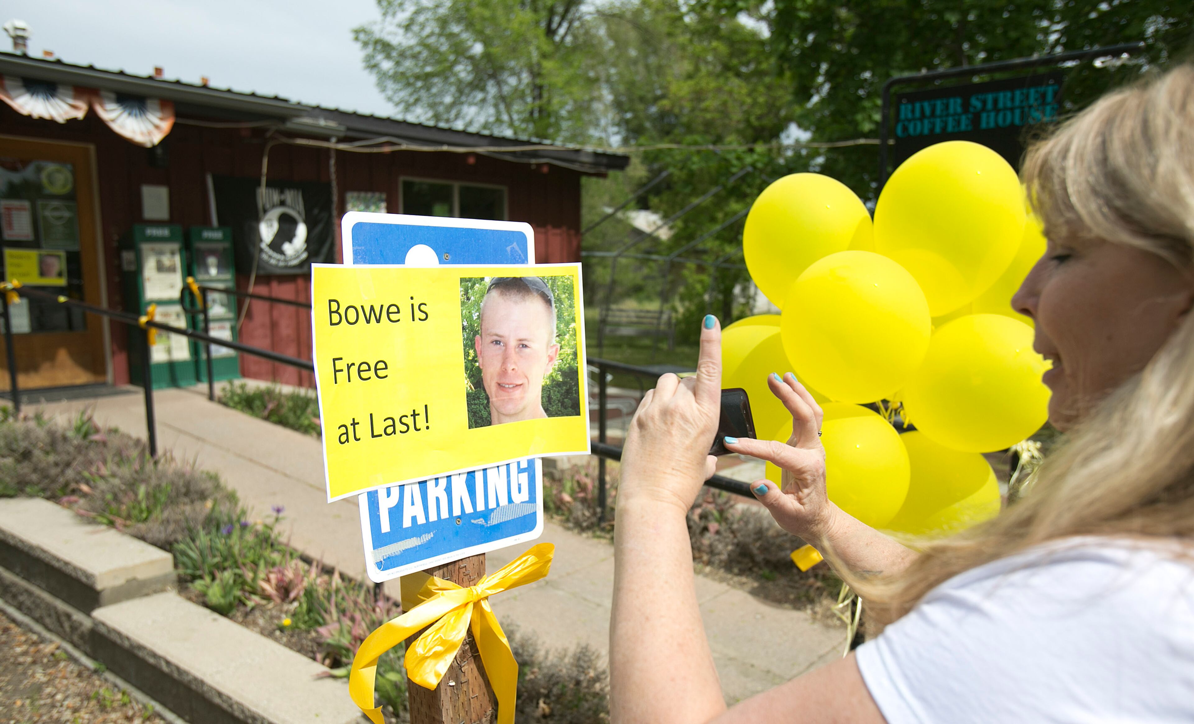 Diane Walker takes a picture of a sign celebrating U.S. Army Sgt. Bowe Bergdahl's release in front of Zaney's coffee shop in Hailey, Idaho. Bergdahl, 28, had been held prisoner by the Taliban since June 30, 2009. He was handed over to U.S. special forces by the Taliban in exchange for the release of five Afghan detainees held by the United States. (AP Photo/The Idaho Statesman, Kyle Green)