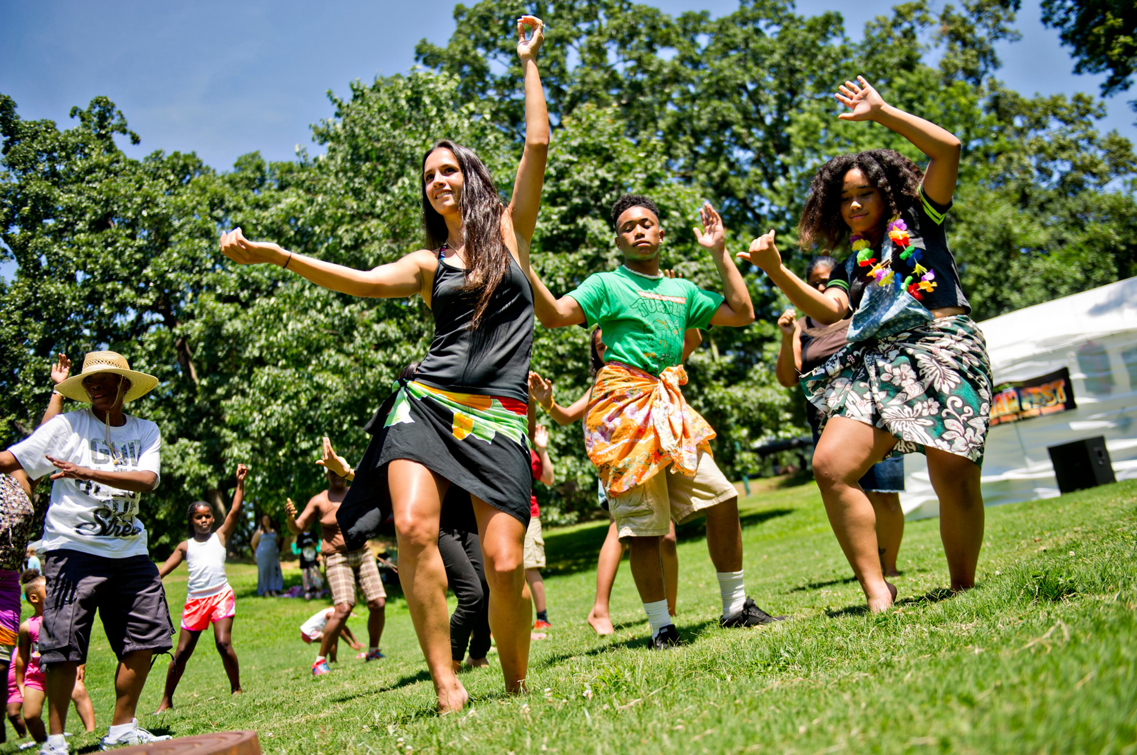 Coty Noojin (center) leads a hula dancing lesson as R.J. Isaac and his sister Deinnah try to follow along during the Nezian Festival at Grant Park in Atlanta on Saturday, July 5, 2014. The two day festival brought together the culture and traditions of the South Pacific Islands with dance and music performances, food and local merchants.
