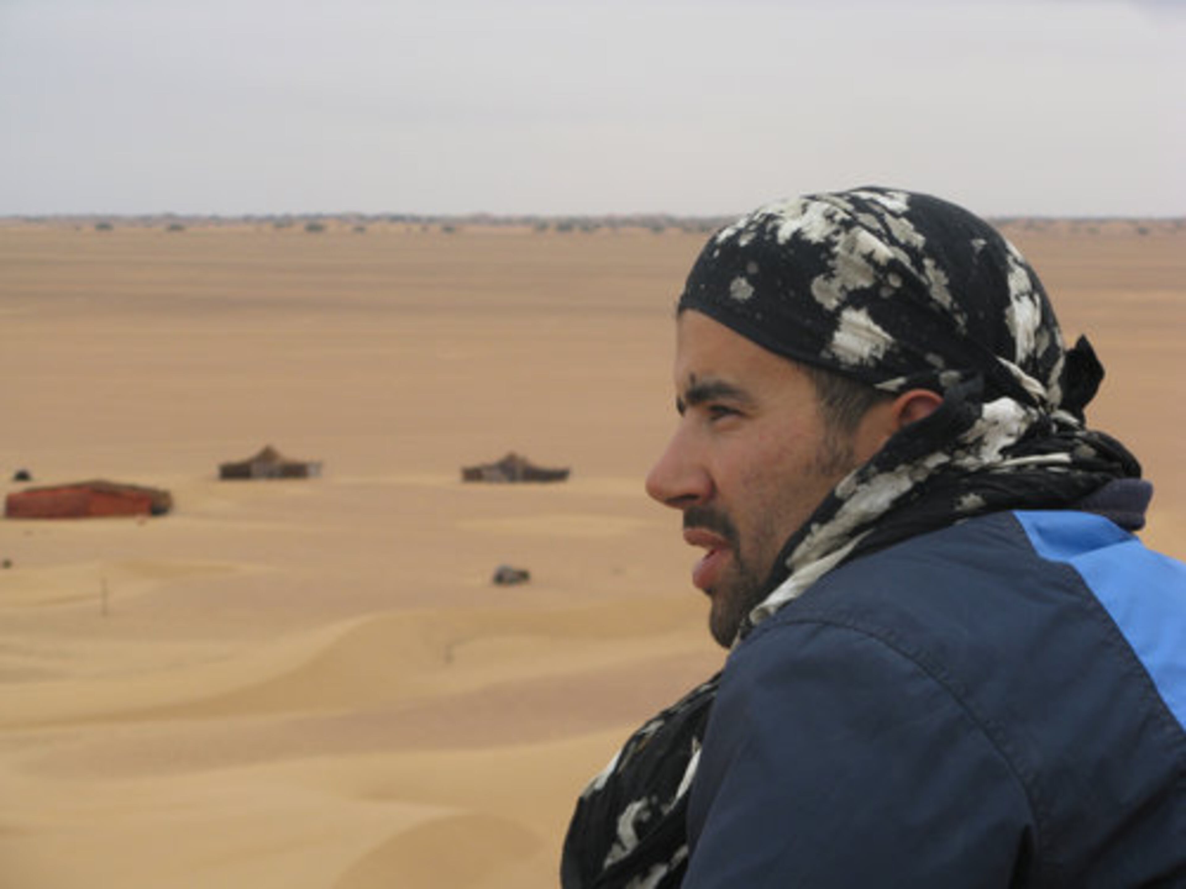 Hassan, our guide, surveys the landscape of the Sahara Desert from atop a dune on our second day in the desert.
