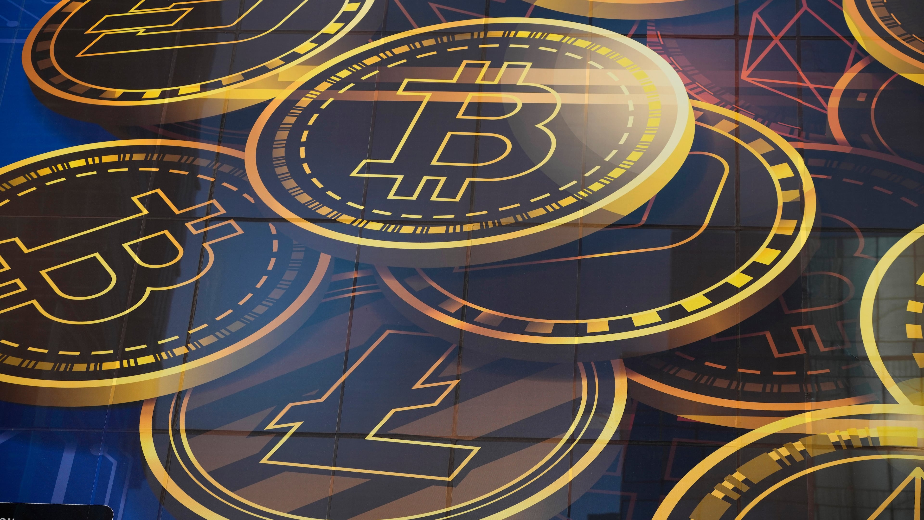FILE - An advertisement for the cryptocurrency Bitcoin is displayed on a building in Hong Kong on Nov. 18, 2021. (AP Photo/Kin Cheung, File)