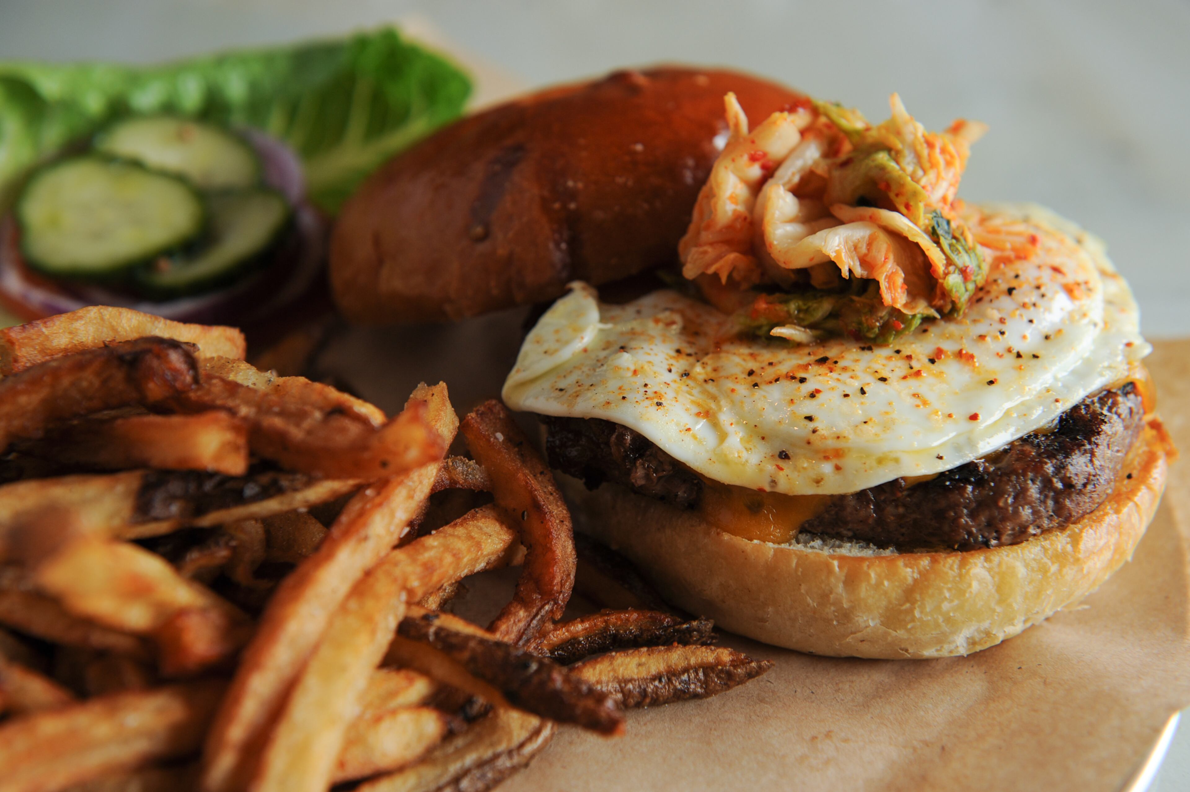 MARCH: John Kessler writes of Pijiu Belly in Midtown,"Pijiu Belly, with its dart board and picnic tables, feels more confident in its mission as a pub where you can taste the real flavors of Shou’s native Korea." Read the full review here. Pictured: The Pijiu Burger- fried egg, kim chi, cheese, beer-bbq sauce. (Beckysteinphotography.com)