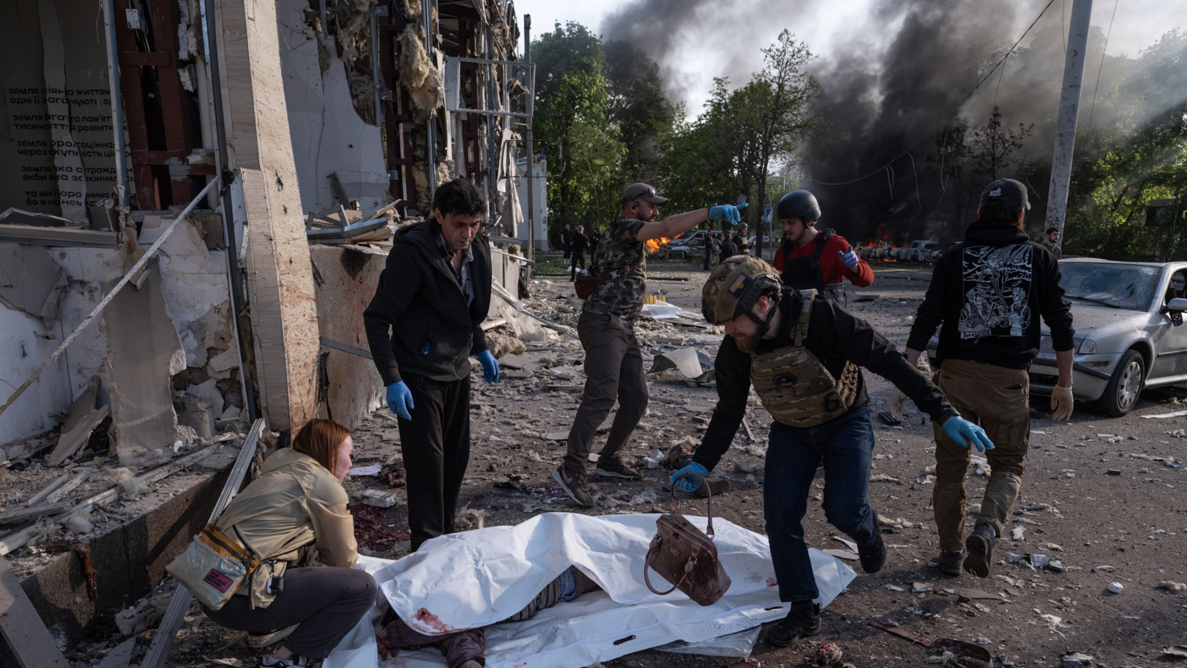 In this photo provided by Ukraine's 93rd Kholodnyi Yar Separate Mechanized Brigade press service, people cover bodies of civilians killed in Russia's aerial guided bomb attack in Kramatorsk, Donetsk region, Ukraine, Tuesday, May 5, 2026. (Iryna Rybakova/Ukraine's 93rd Mechanized Brigade via AP)