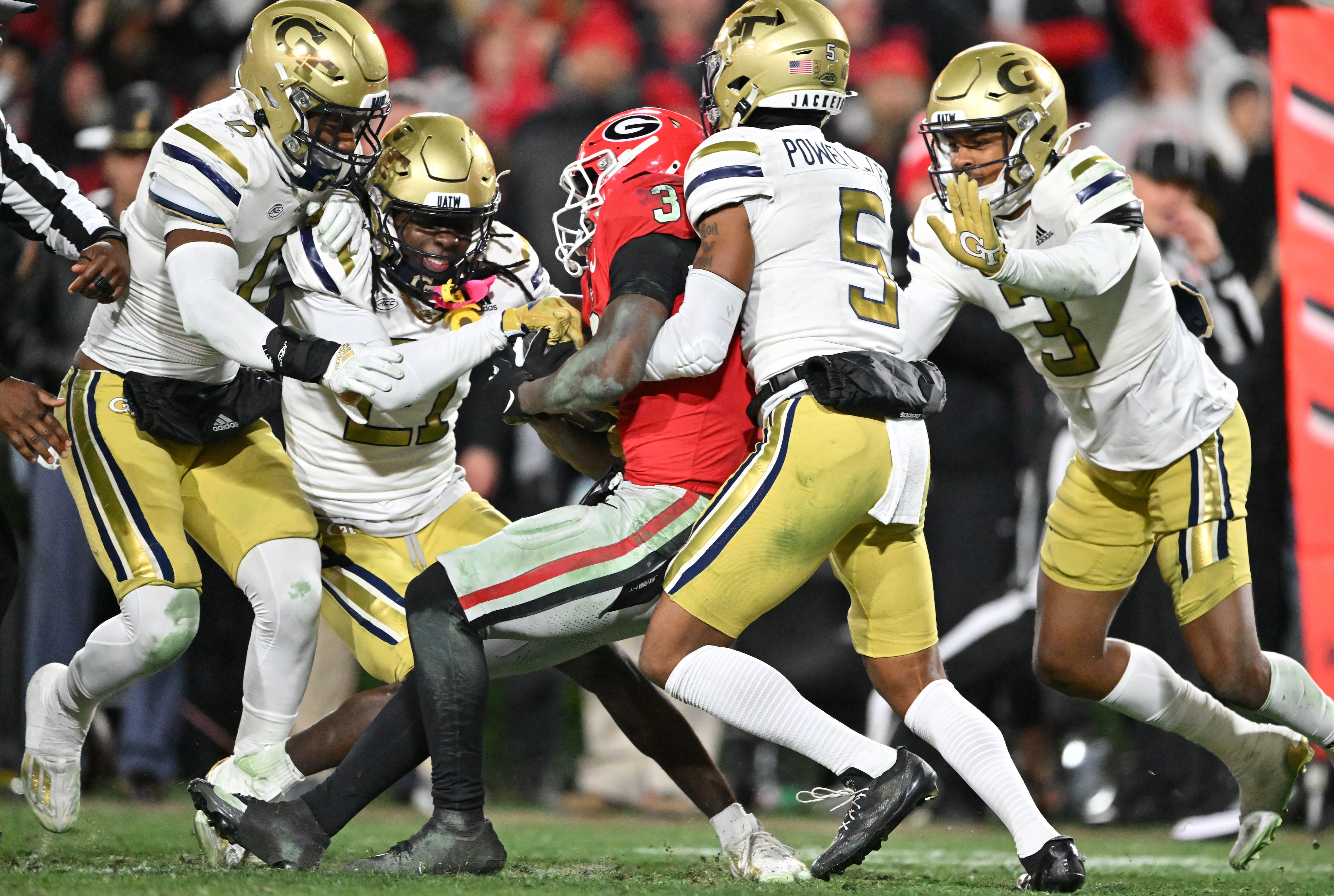 Georgia running back Nate Frazier (3) gets tackled by Georgia Tech defensive back Clayton Powell-Lee (5) during the second half in an NCAA football game at Sanford Stadium, Friday, November 29, 2024, in Athens. Georgia won 44-42 in eight overtimes. (Hyosub Shin / AJC)