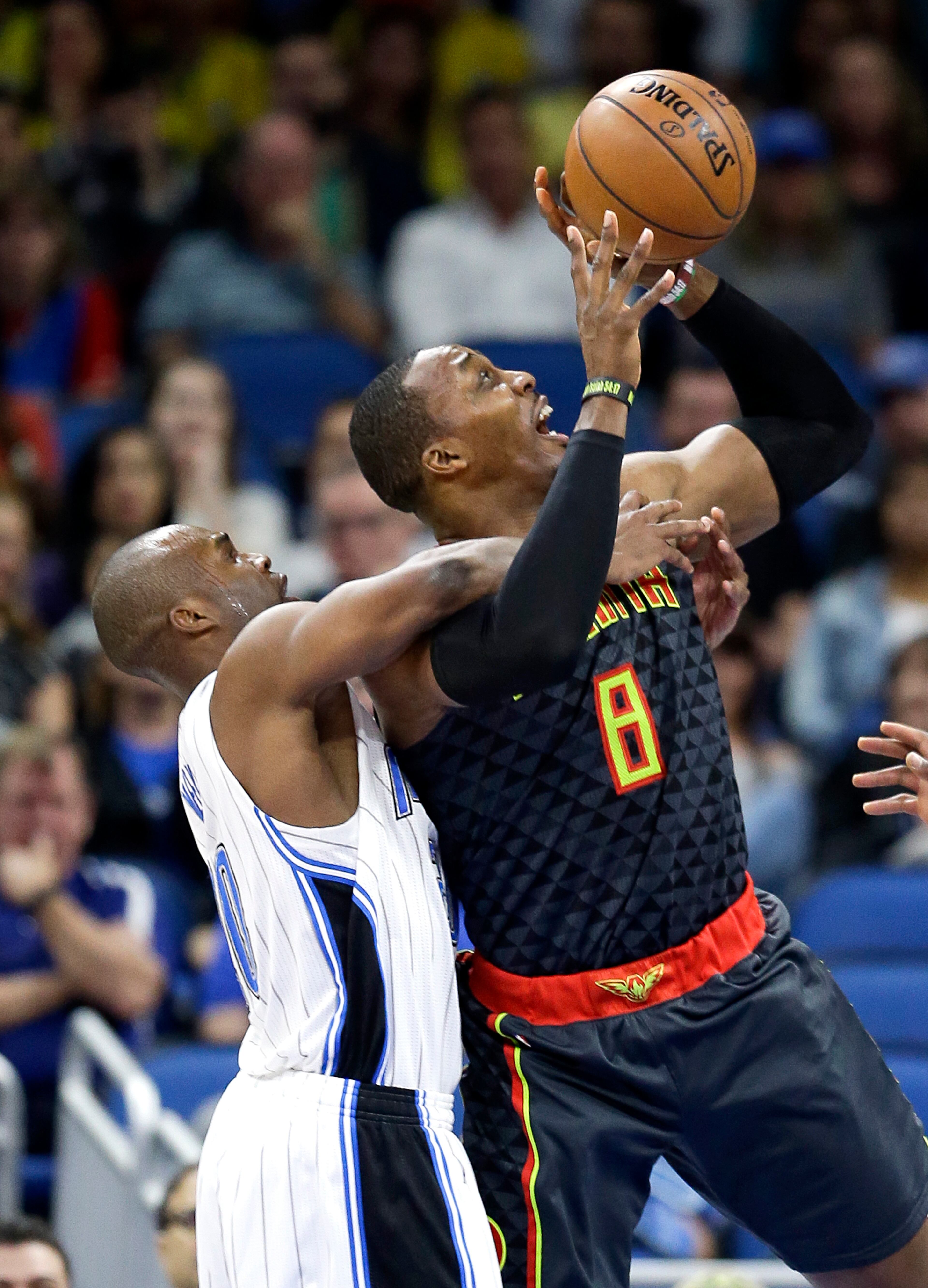 Atlanta Hawks' Dwight Howard, right, is fouled by Orlando Magic's Jodie Meeks, left, as he attempts a shot during the first half of an NBA basketball game, Wednesday, Jan. 4, 2017, in Orlando, Fla. (AP Photo/John Raoux)