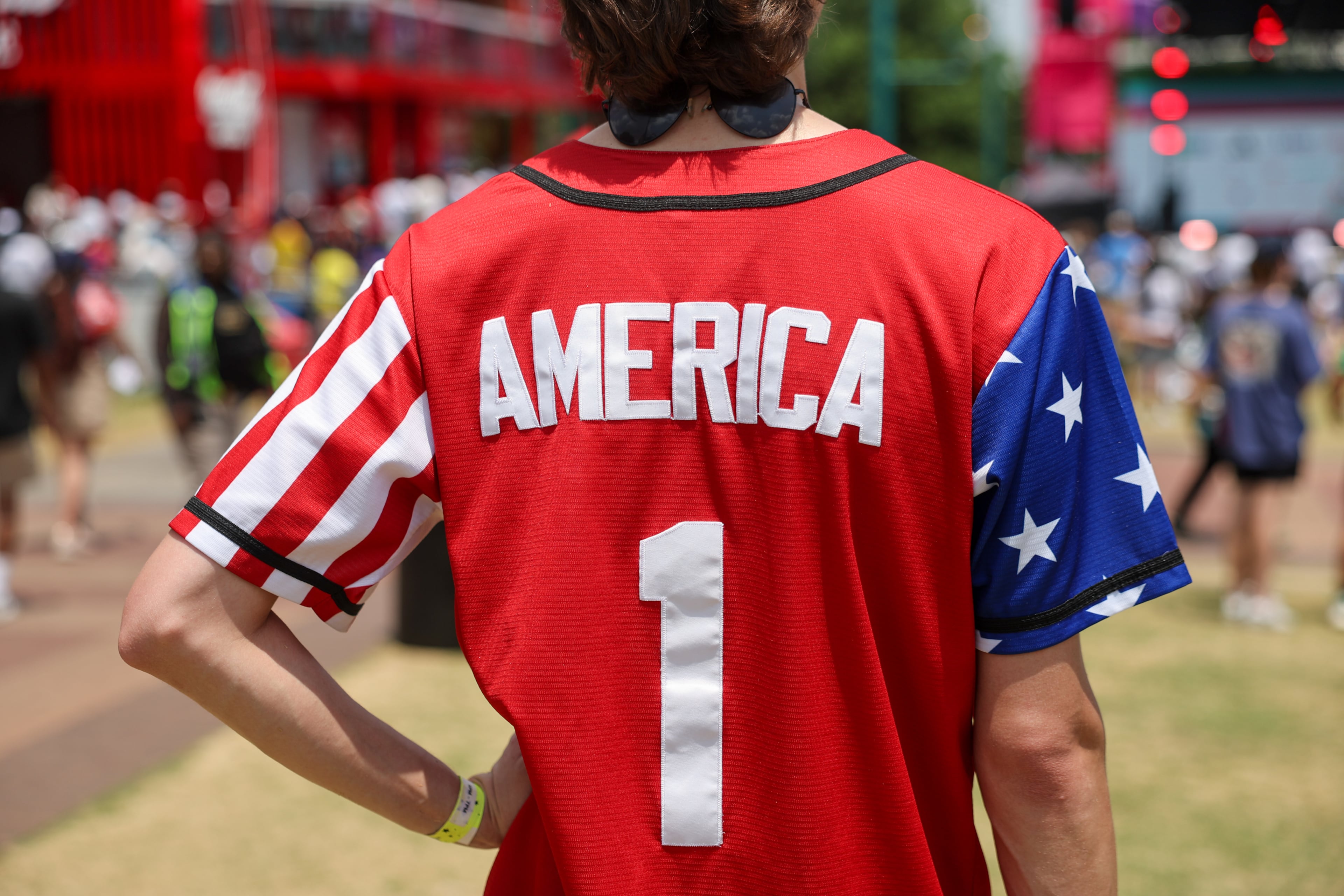 A fan wears an America jersey at Fan Fest in Centennial Olympic Park in Atlanta in the second half of the England versus Congo FIFA World Cup game on July 1, 2026. The game was played in Atlanta Stadium (Mercedes Benz Stadium) for the knockout round of 32. England won 2-1. (Arvin Temkar/AJC)