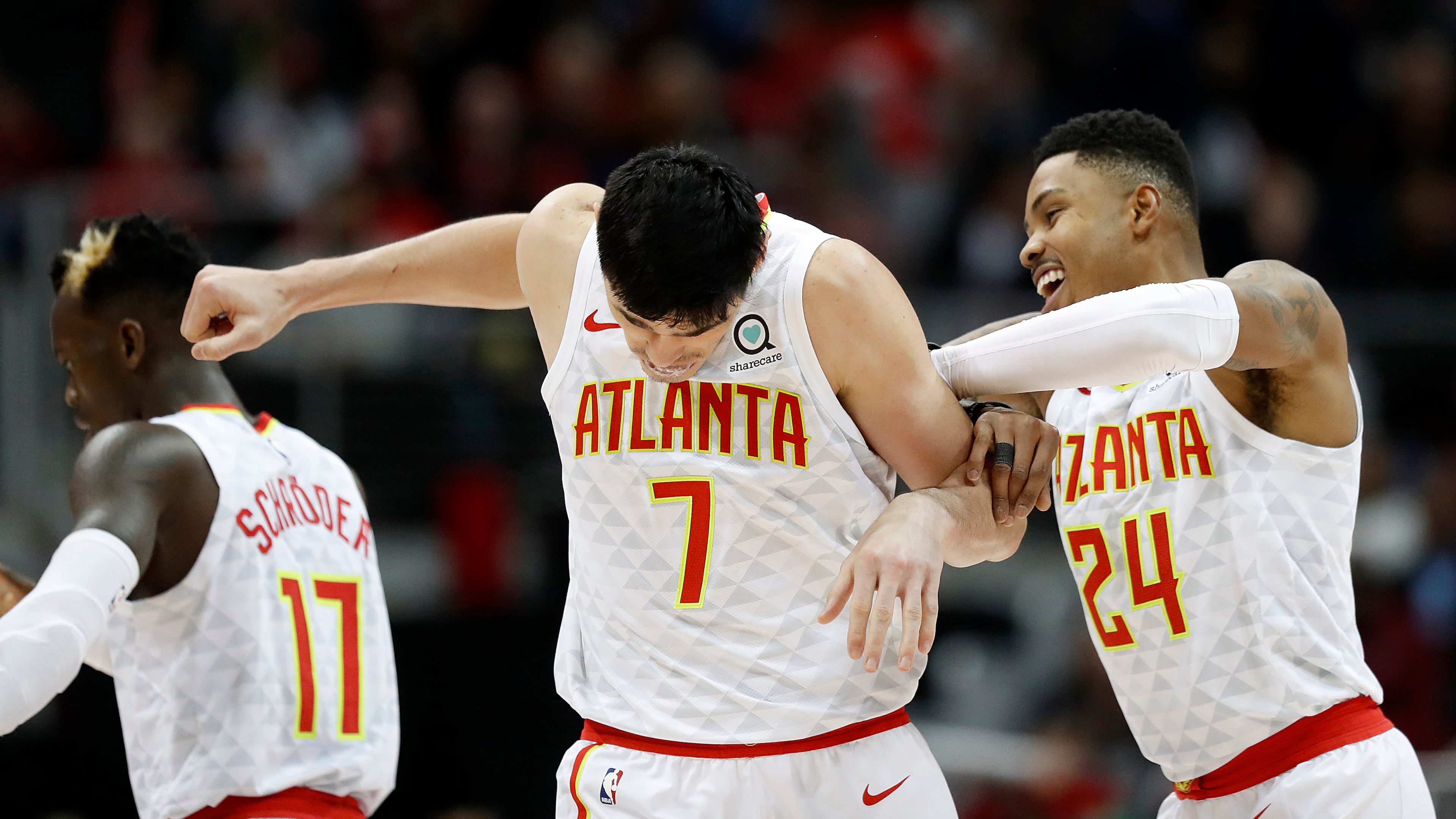 Atlanta Hawks' Kent Bazemore, right, celebrates with teammate Ersan Ilyasova, , center, after Ilyasova scored in the fourth quarter of an NBA basketball game against the Washington Wizards in Atlanta, Wednesday, Dec. 27, 2017. (AP Photo/David Goldman)