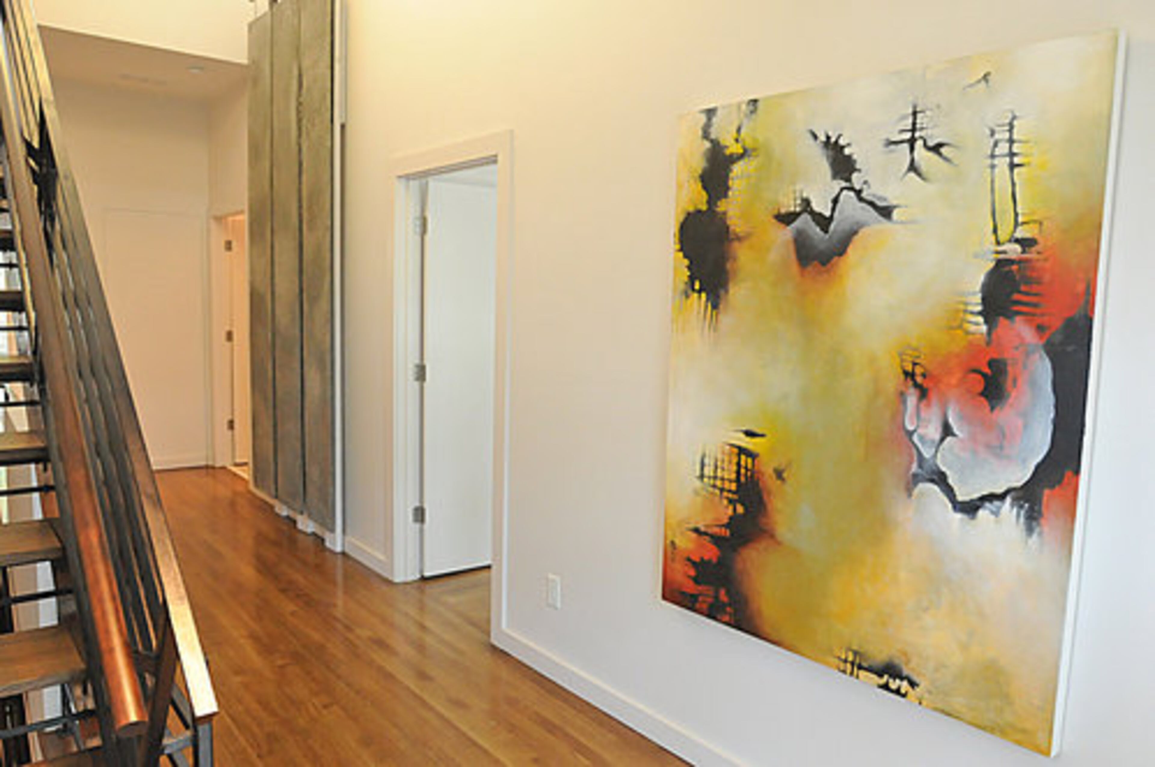 The couple has placed wall art strategically to open up spaces such as this landing area.