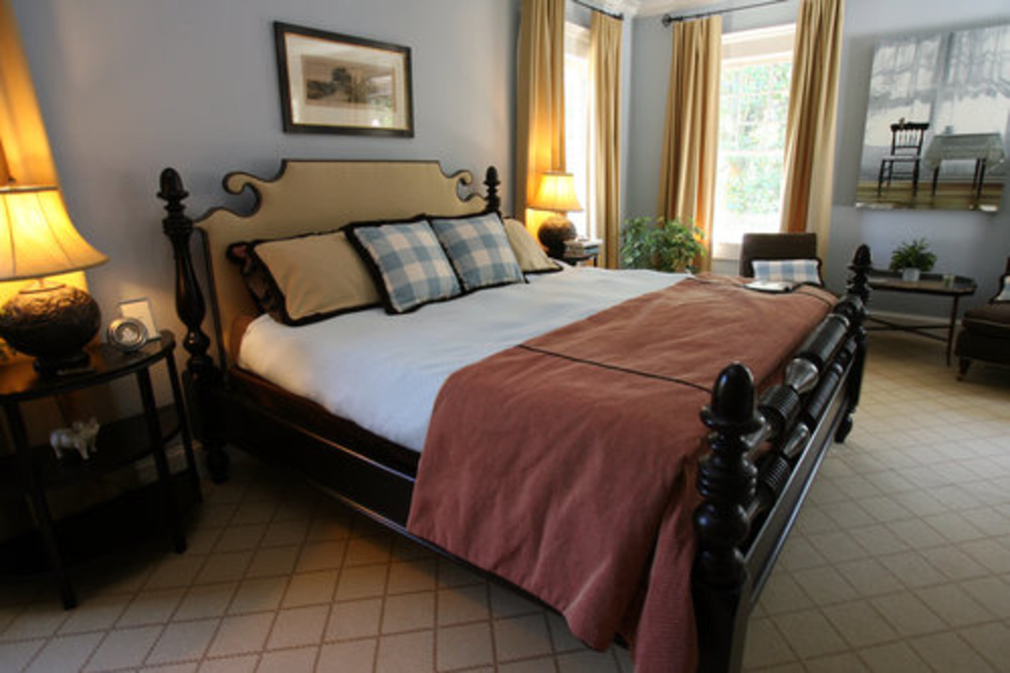 The master bedroom offers a carpeted floor and soft blue painted walls.