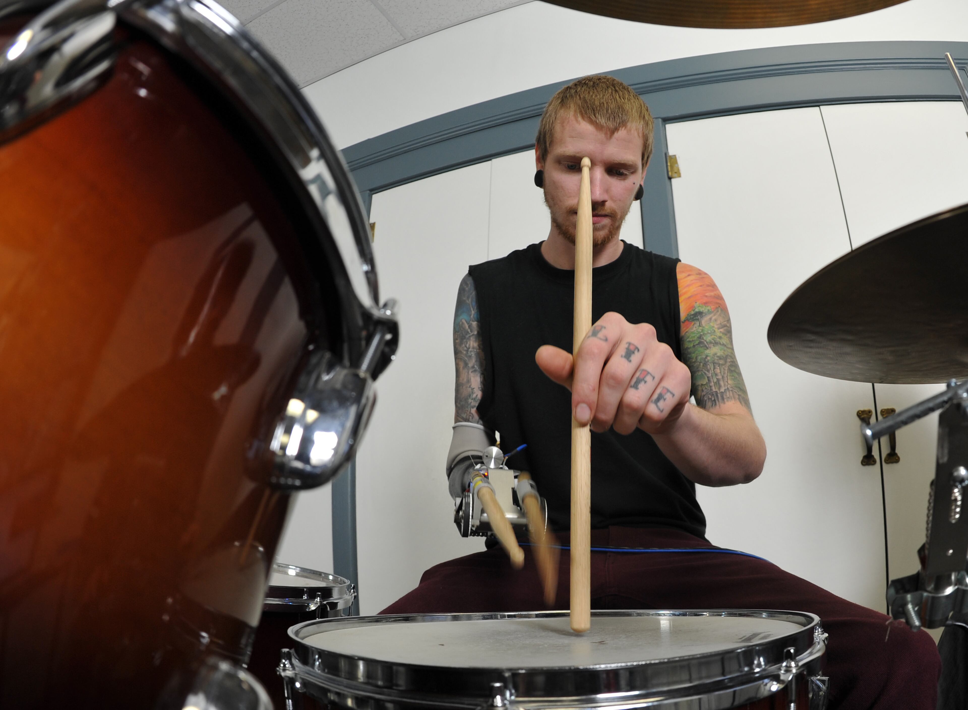 Rock, blues and jazz drummer Jason Barnes lost his right hand in an accident but a team of Georgia Tech robotics specialists devised a myo-electrically controlled robot arm to replace his missing drumming hand and they fine-tune the new wearable drumming device in the music lab Sunday, March 16, 2014, in Atlanta. David Tulis / AJC Special