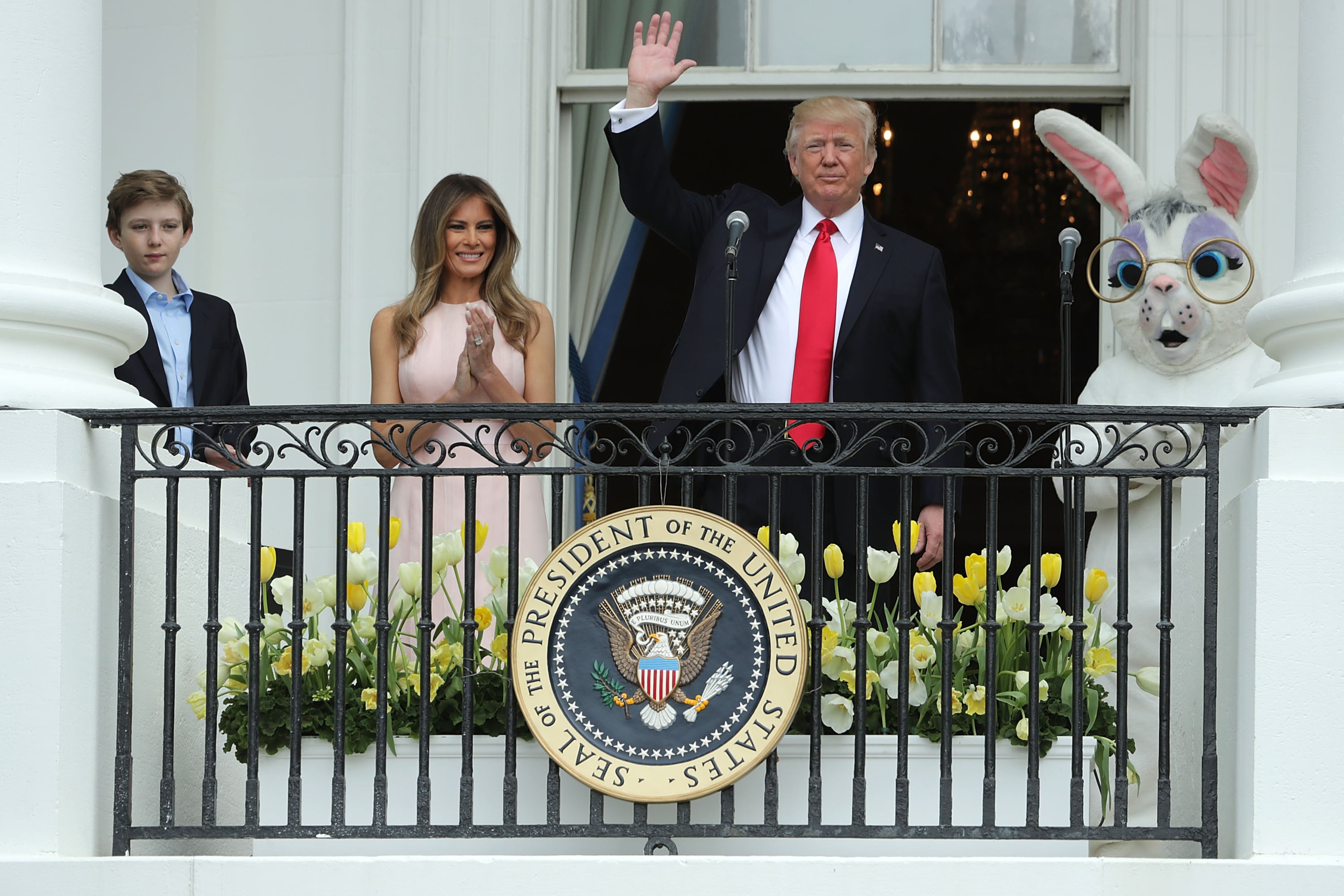 WASHINGTON, DC - APRIL 17: U.S. President Donald Trump (C) waves to guests after delivering remarks from the Truman Balcony with first lady Melania Trump and their son Barron Trump (L) during the 139th Easter Egg Roll on the South Lawn of the White House April 17, 2017 in Washington, DC. The White House said 21,000 people are expected to attend the annual tradition of rolling colored eggs down the White House lawn that was started by President Rutherford B. Hayes in 1878. (Photo by Chip Somodevilla/Getty Images)
