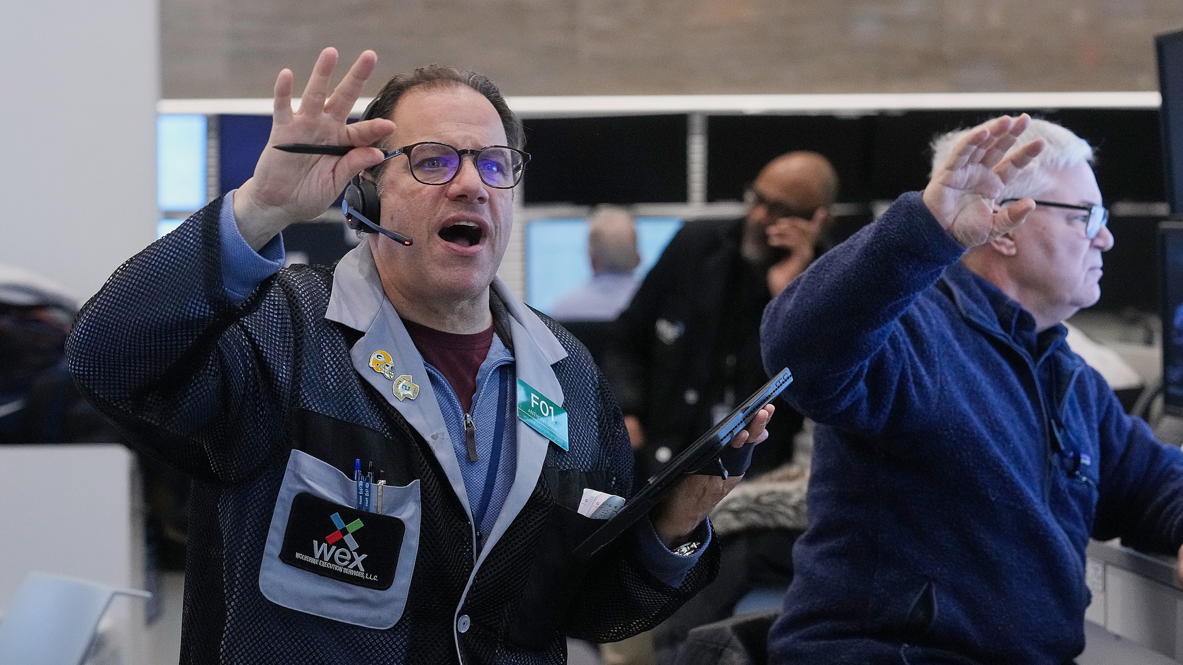 Anthony Spina, left, works with fellow options traders on the floor of the New York Stock Exchange, Wednesday, Jan. 28, 2026. (AP Photo/Richard Drew)