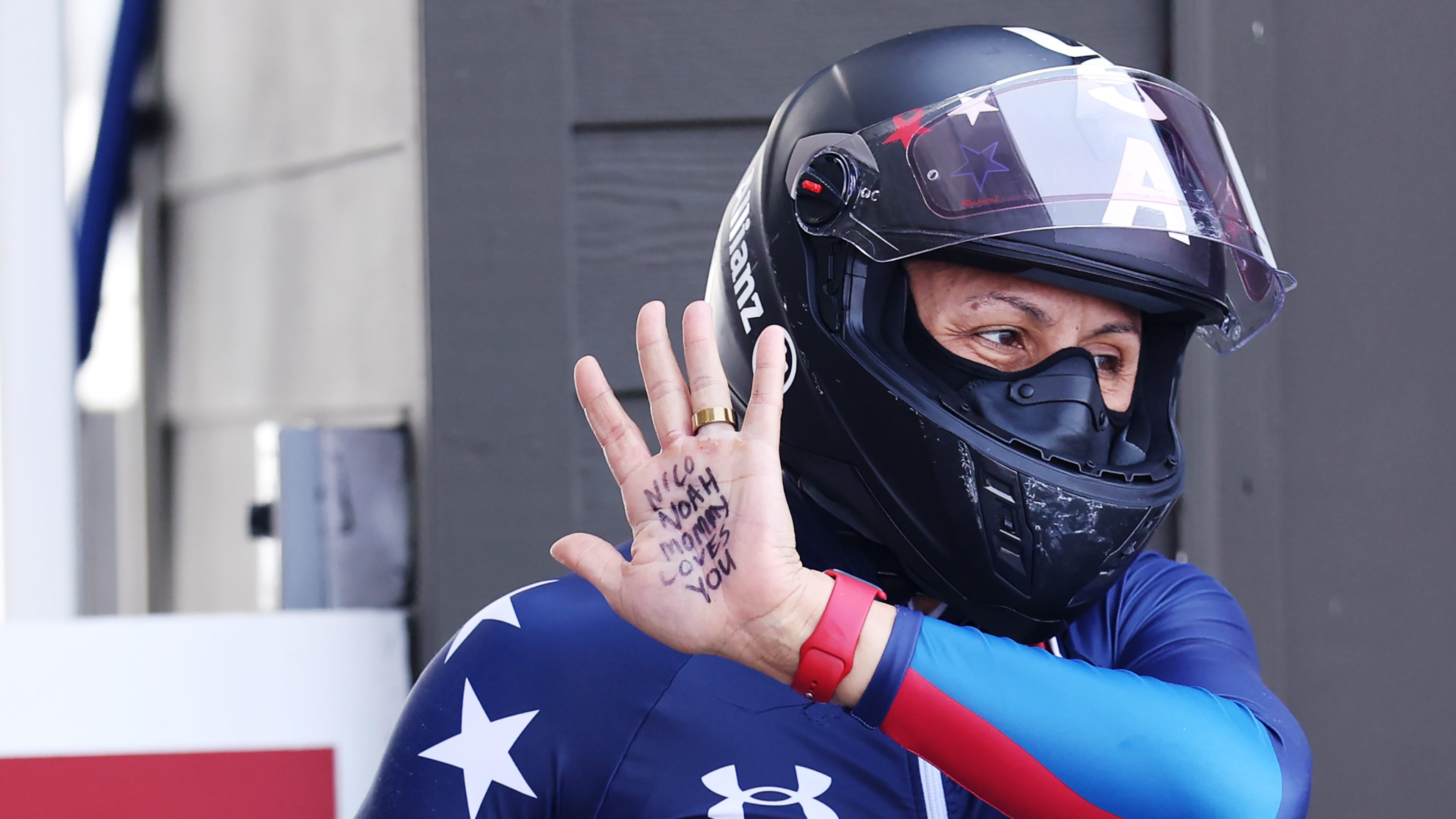 Elana Meyers Taylor holds up her hand, displaying a message to her sons Nico and Noah, during the two-woman bobsled race at the 2025 World Championships in Lake Placid, New York. (Maddie Meyer/Getty Images)