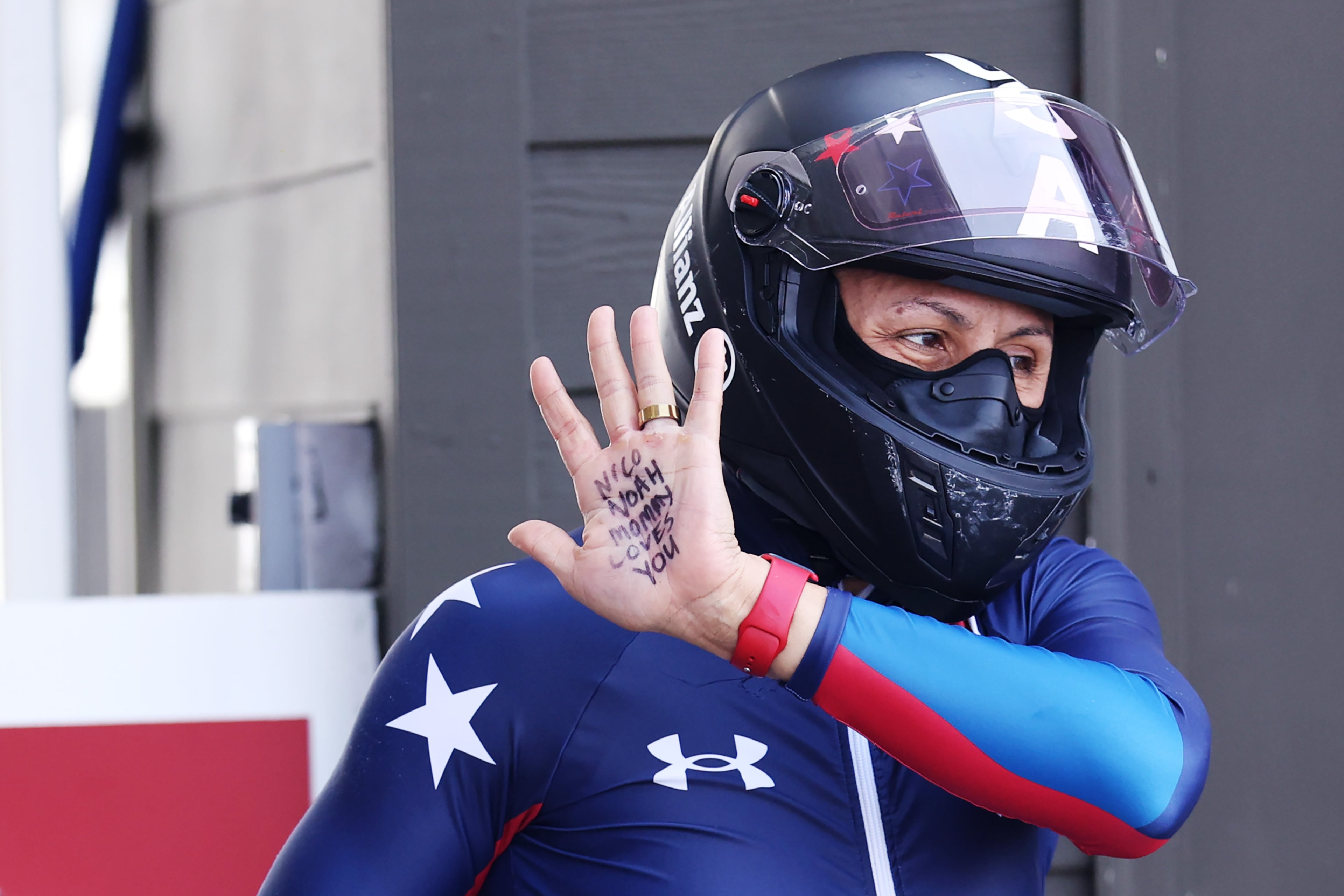Elana Meyers Taylor holds up her hand, displaying a message to her sons Nico and Noah, during the two-woman bobsled race at the 2025 World Championships in Lake Placid, New York. (Maddie Meyer/Getty Images)