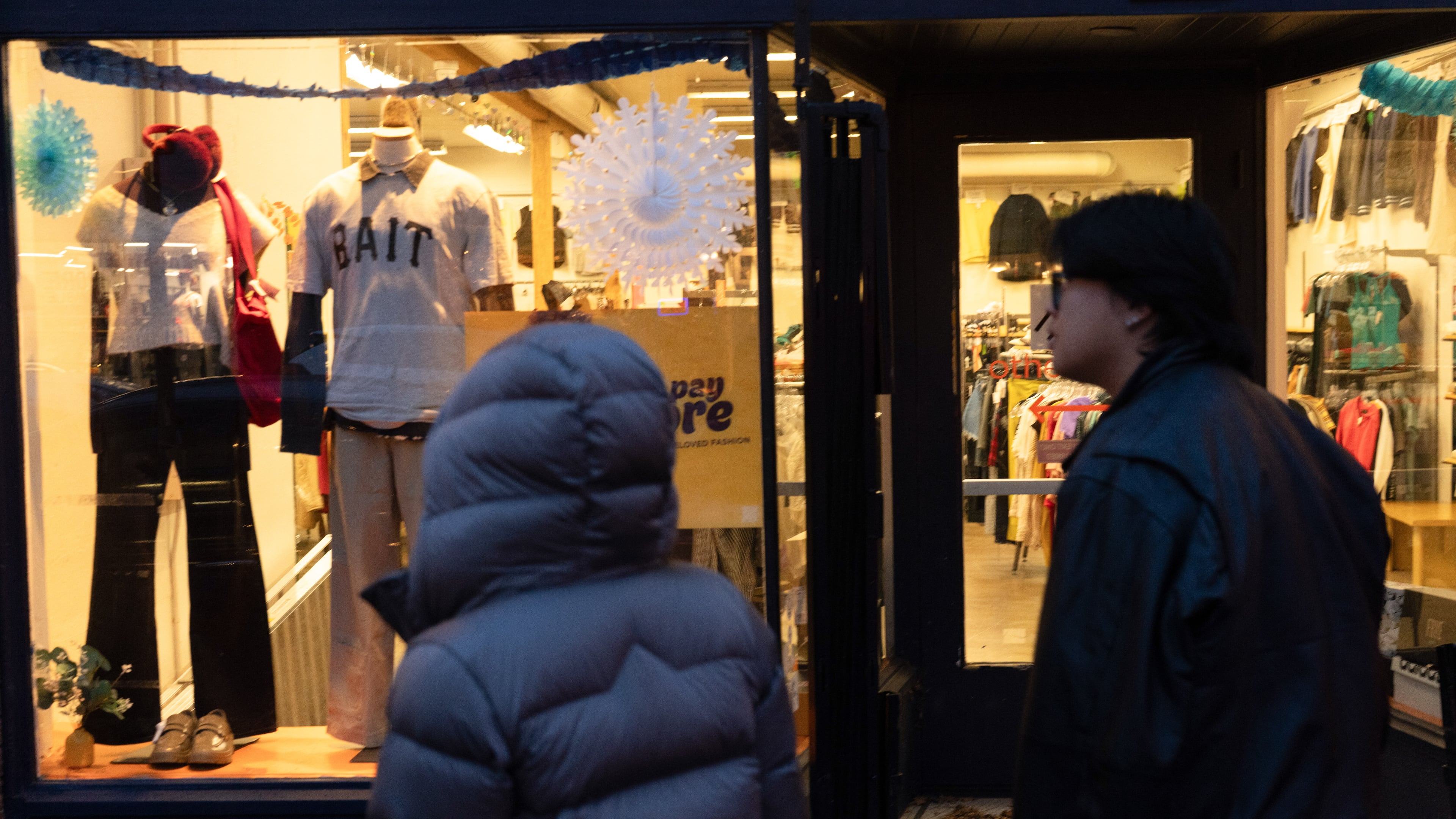 People walk by a shop on Tuesday, Jan. 6, 2026, in Portland, Ore. (AP Photo/Jenny Kane)