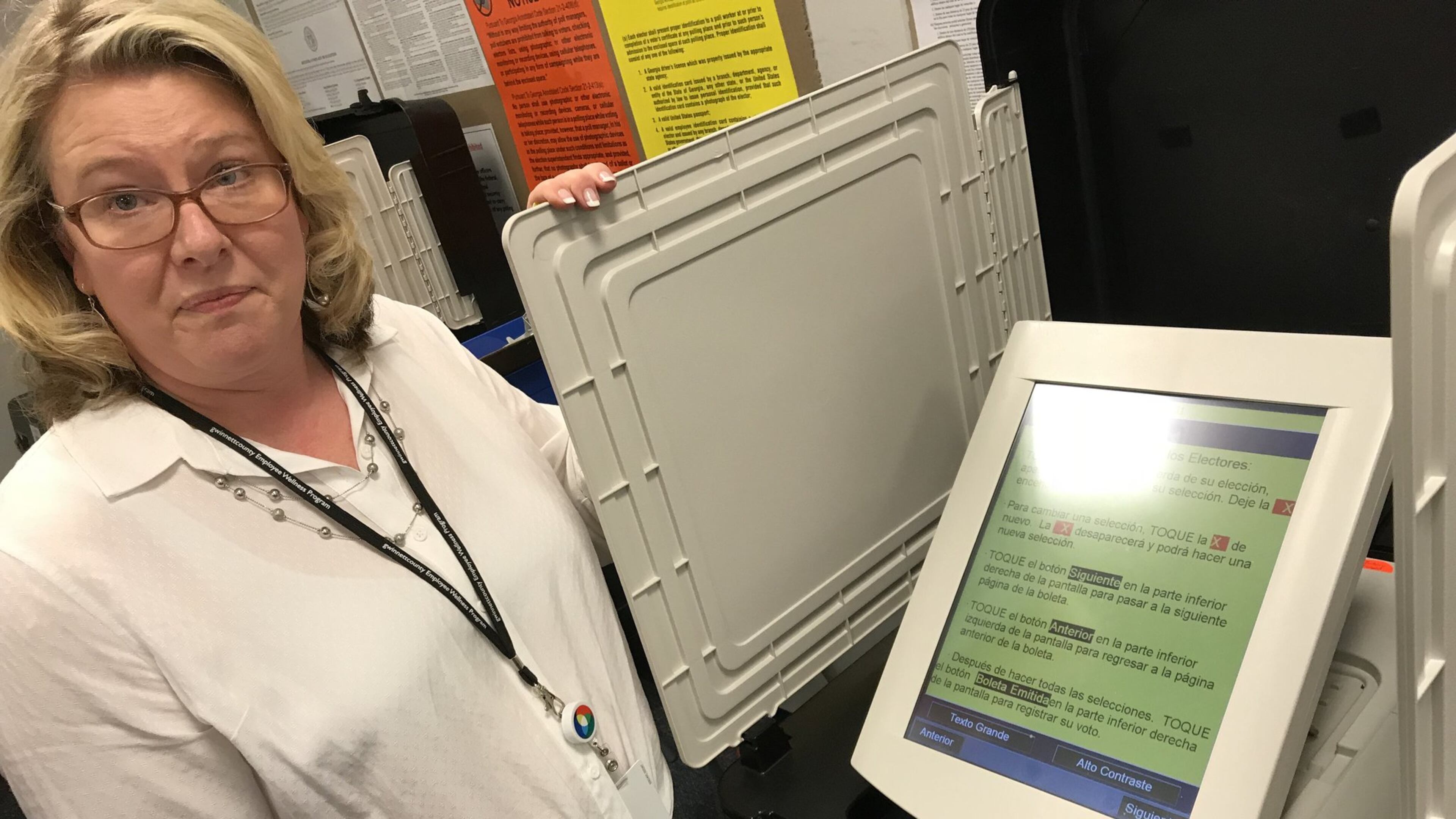 In this April 2018 file photo, Gwinnett elections director Lynn Ledford shows off a voting machine’s Spanish-language ballot. TYLER ESTEP / TYLER.ESTEP@AJC.COM