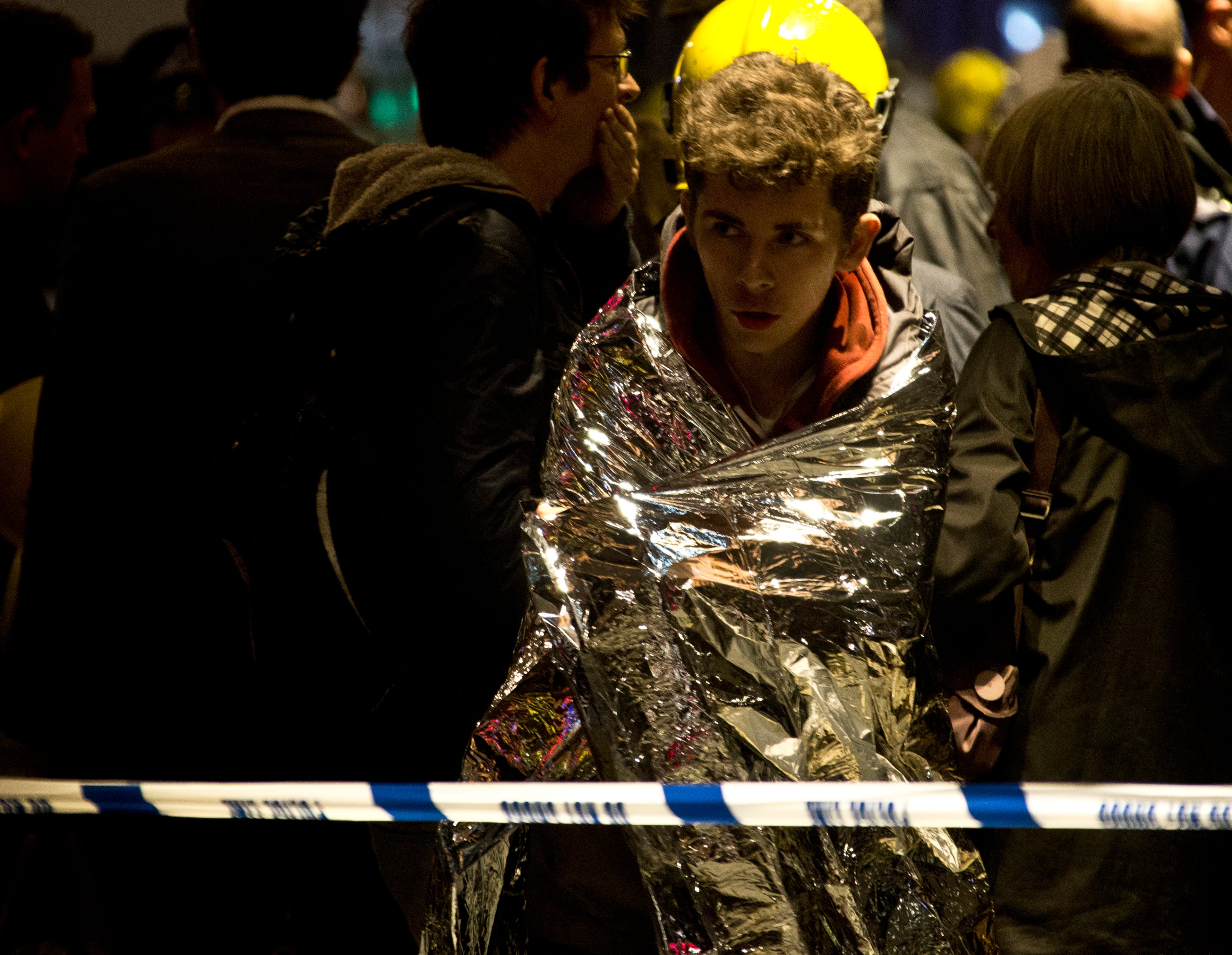 A man wraps himself in an emergency foil blanket provided by rescue services following an incident at the Apollo Theatre, in London's Shaftesbury Avenue, Thursday evening, Dec. 19, 2013 during a performance , with police saying there were "a number" of casualties. It wasn't immediately clear if the roof, ceiling or balcony had collapsed. The London Fire Brigade said the theatre was almost full, with around 700 people watching the performance. A spokesman added: "It's thought between 20 and 40 people were injured."
