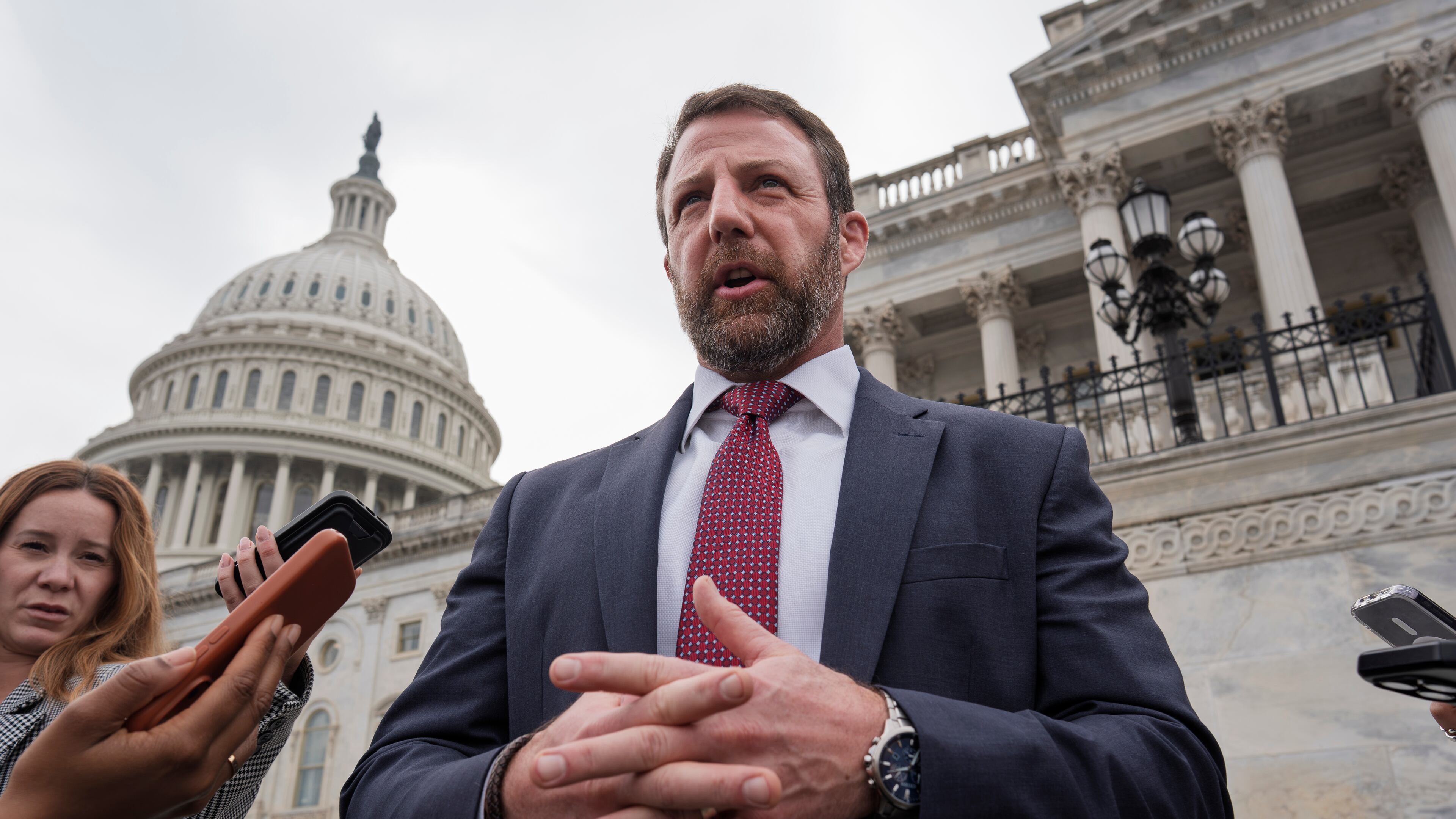 Sen. Markwayne Mullin, R-Okla., speaks with reporters on the steps at the Capitol in Washington, Thursday, March 5, 2026. (AP Photo/J. Scott Applewhite)