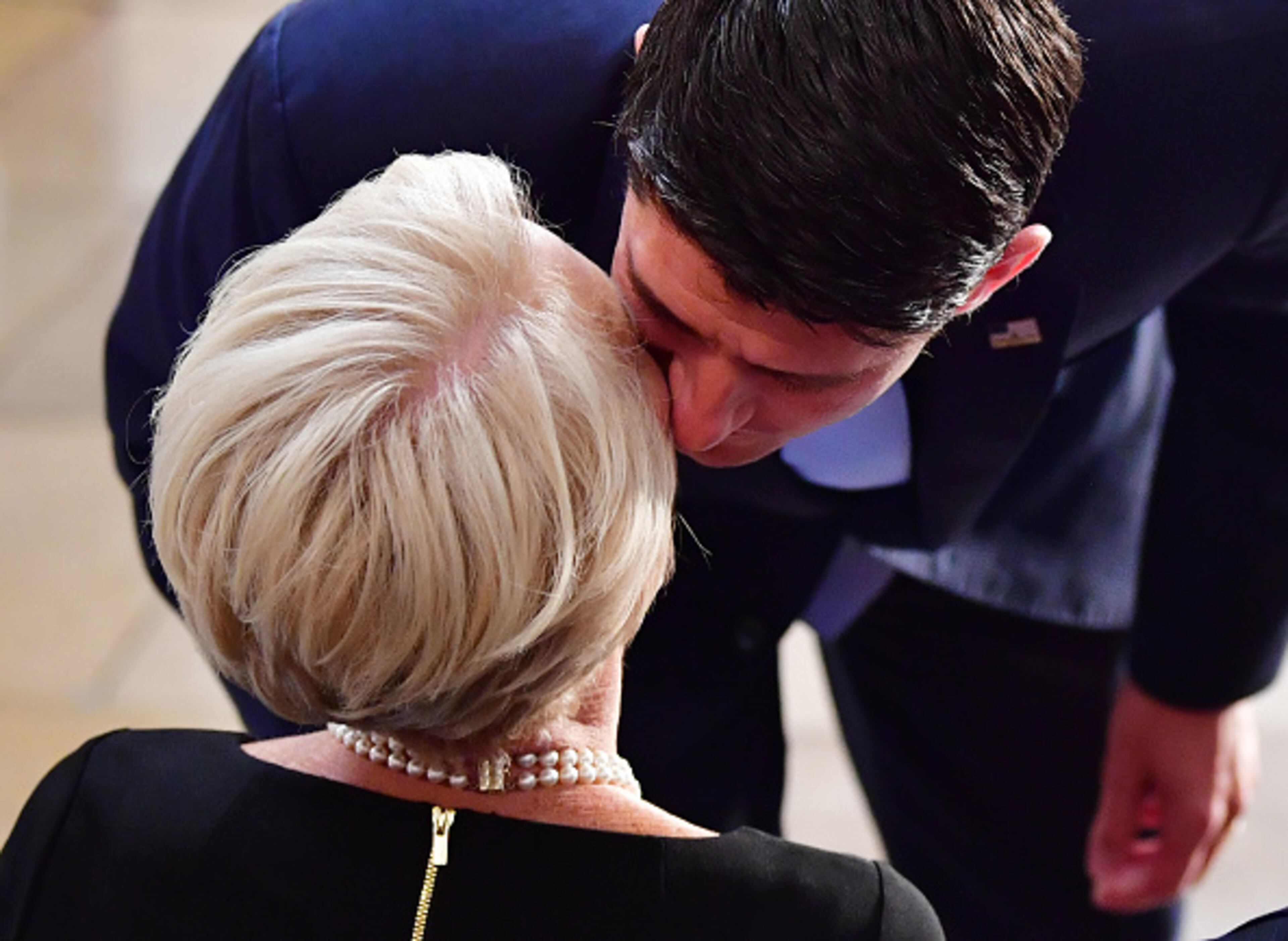 WASHINGTON, DC - AUGUST 31: Speaker of the United States House of Representatives Paul Ryan kisses Cindy McCain as the casket of former Senator John McCain in the Capitol Rotunda lies in state at the U.S. Capitol, in Washington, DC on Friday, August 31, 2018. McCain, an Arizona Republican, presidential candidate and war hero died August 25th at the age of 81. He is the 31st person to lie in state at the Capitol in 166 years. (Photo by Kevin Dietsch - Pool/Getty Images)