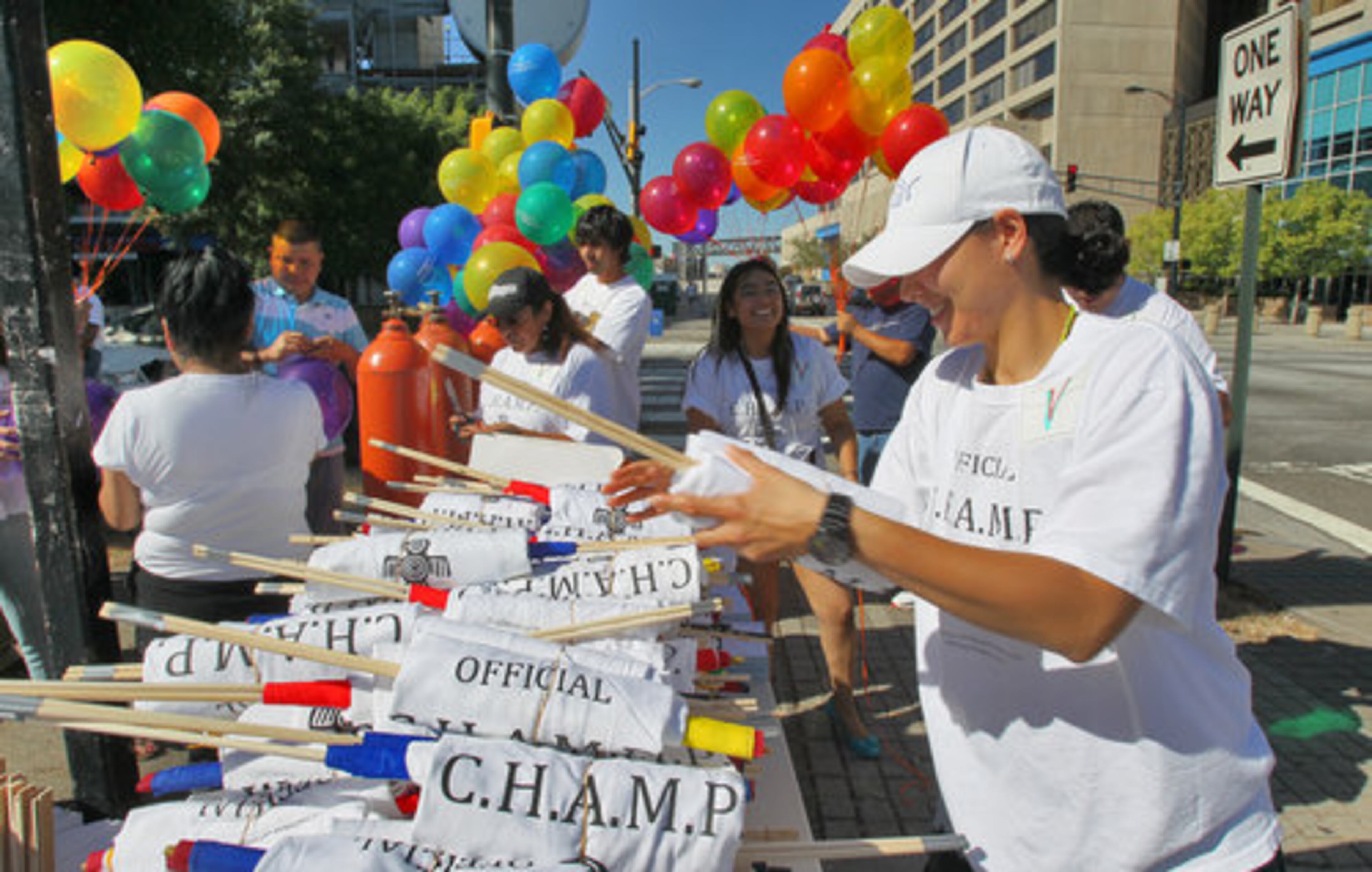 Tennille Ponte of Marietta prepares the T-shirts and flags to hand out to marchers Monday at Marietta Street and Centennial Olympic Park Drive. Some 100 people marched from Centennial Olympic Park to Woodruff Park Monday, September 6, 2010 in the Hispanic Labor Day March sponsored by the Coalition of Hispanic Americans Making Progress, Inc. or C.H.A.M.P.
