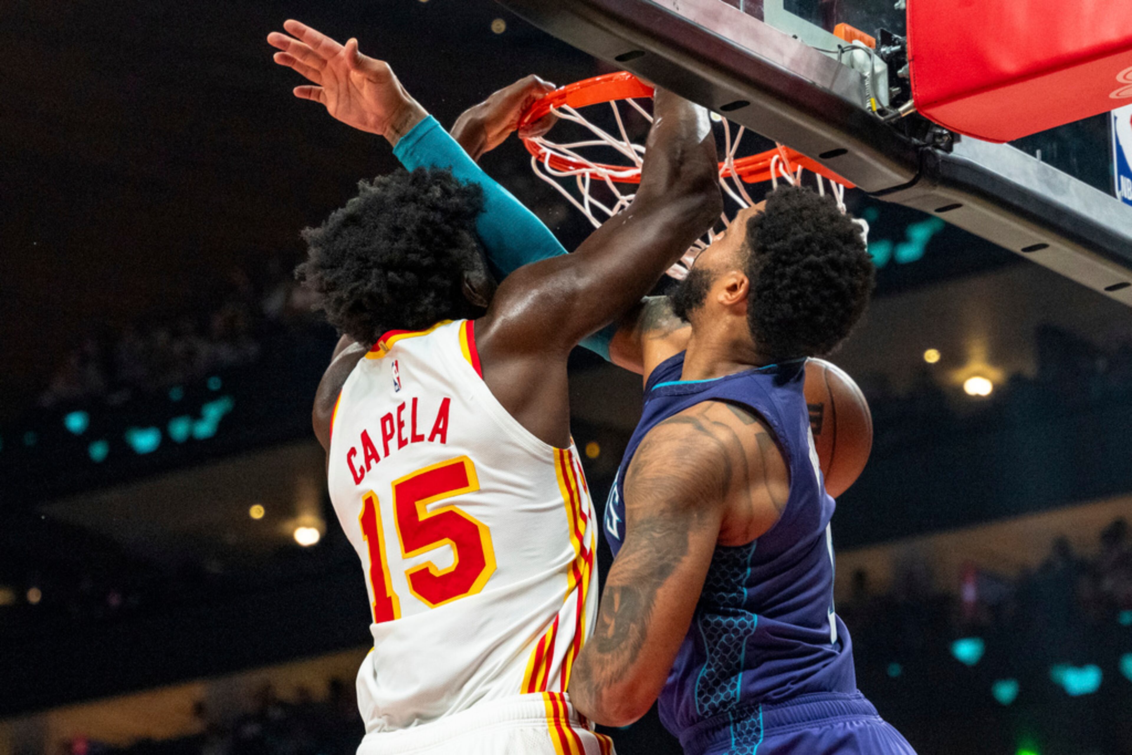 Atlanta Hawks center Clint Capela (15) slam-dunks over Charlotte Hornets forward Miles Bridges, right, during the first half of an NBA basketball game, Friday, Oct. 25, 2024, in Atlanta. The Hawks won 125-120. (AP Photo/Jason Allen)