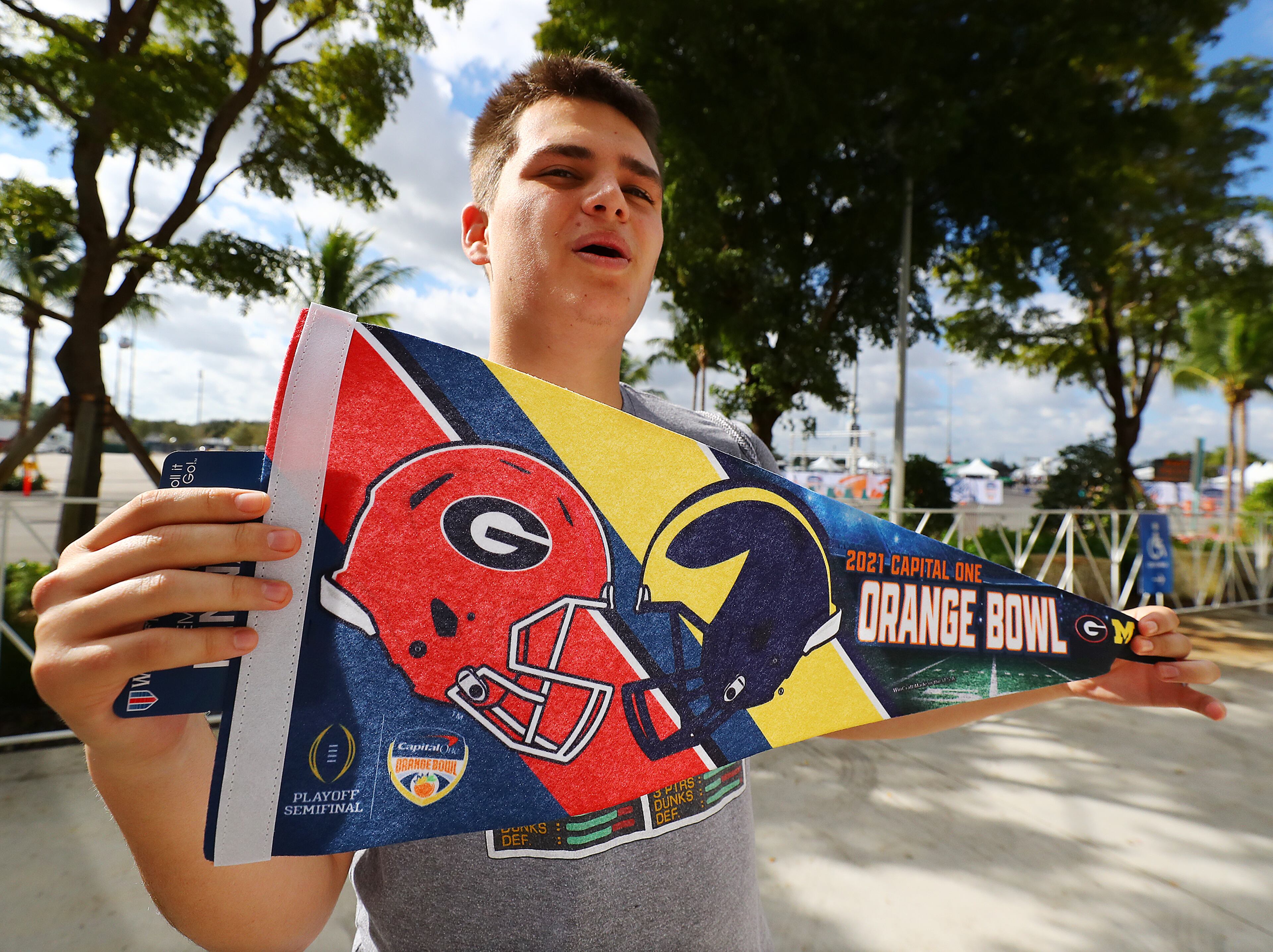 Frankie Freeman, Chicago, who comes to the Orange Bowl every year with his family, shows of this year's pennant. “Curtis Compton / Curtis.Compton@ajc.com”`