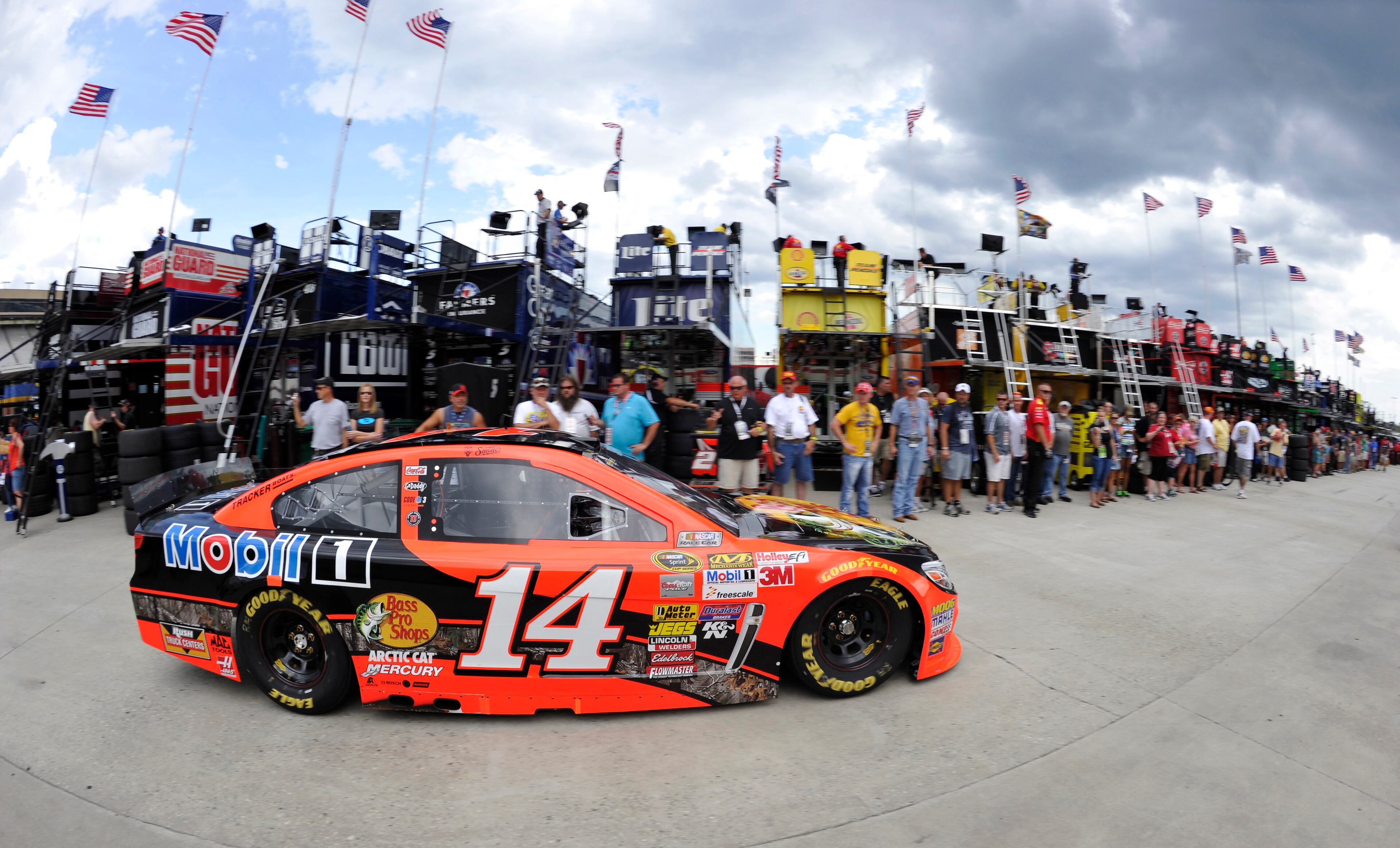 A line of spectators watch as Sprint Cup Series driver Tony Stewart (14) returns to the garage during practice for Sunday's NASCAR Sprint Cup Series auto race at Atlanta Motor Speedway, Saturday, Aug. 30, 2014 in Hampton, Ga. (AP Photo/David Tulis)