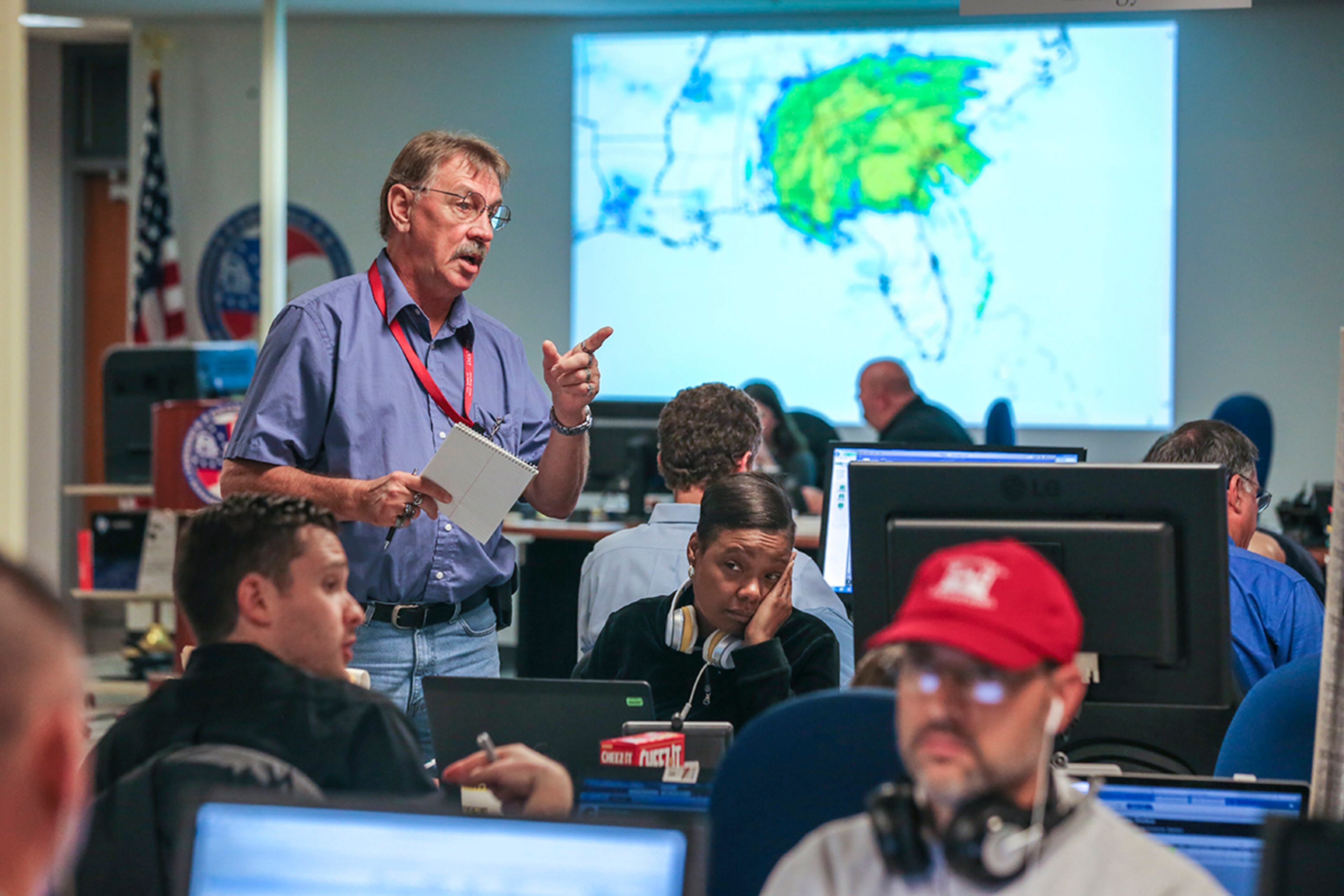 September 11, 2017 Atlanta: With an image behind them showing Irma covering most of the South, workers at GEMA (from left to right) Kyle McPhee, Dan Pitchford (standing) Leticia Mathis and Jeff Morris work the storm Monday morning.Tropical storm, Irma began to make its presence know in Atlanta on Monday, Sept. 11, 2017. The storm claimed at least one life in Georgia, state emergency management officials said Monday. The death occurred in Worth County. Further details werenât immediately available. Irmaâs staggering march up into northern Florida was expected to bring high winds and heavy rains to Atlanta Monday afternoon â though perhaps not quite as high or as heavy as earlier feared. Georgia Powerâs outage map showed 400,000 of its customers were down, and the electric membership cooperatives, as of 12:45 p.m., added another 268,000 to the total. Most of the failures were along the Georgia coast and in South Georgia. But the outages began to creep northward: 22,000 metro Atlanta customers had no power as of 12:20 p.m., the Georgia Power map showed. JOHN SPINK/JSPINK@AJC.COM