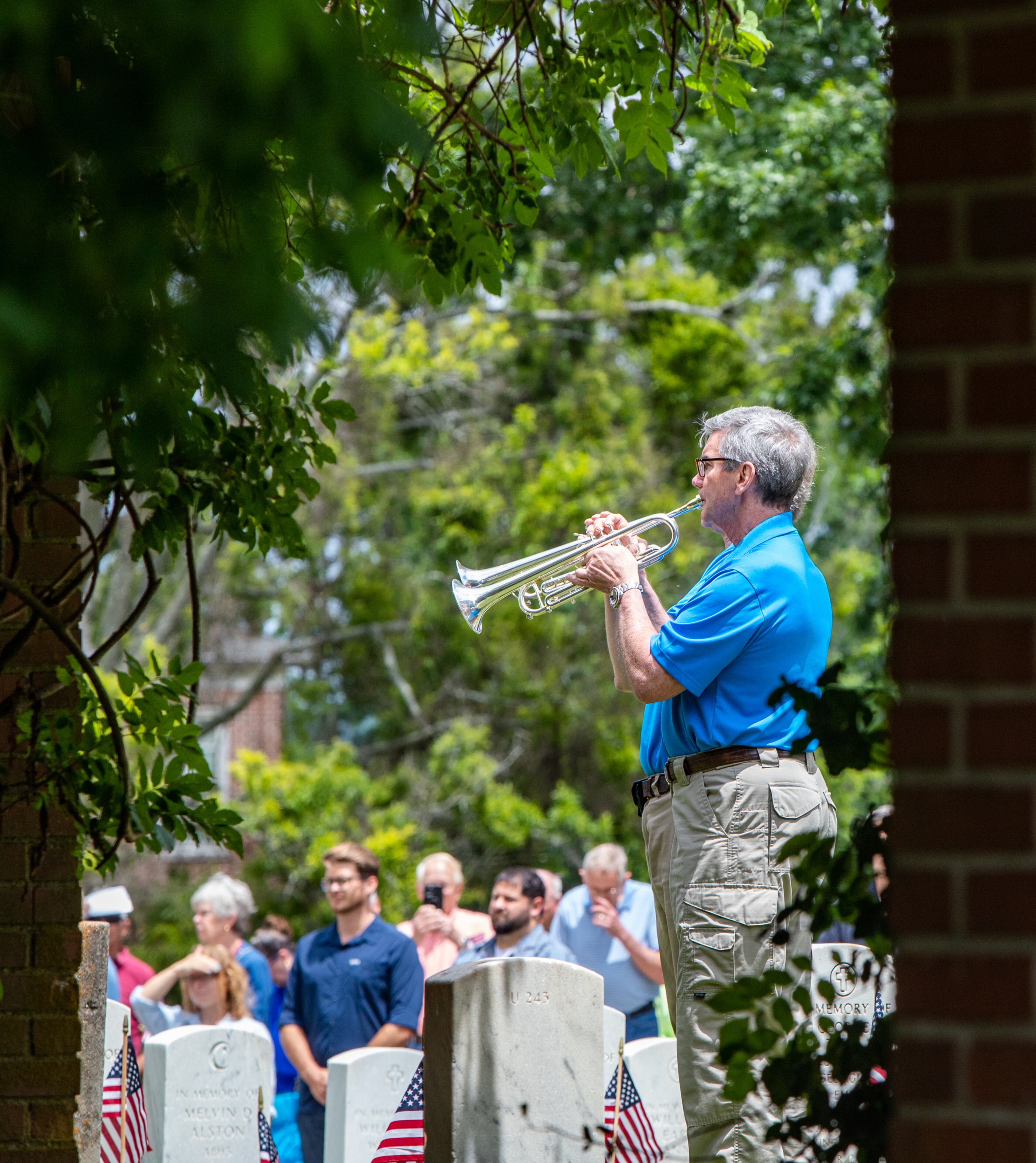 The Atlanta Concert Guard’s David Stoutamire of Sandy Springs, front, performs taps closing out the the 77th annual Memorial Day Observance at the Marietta National Cemetery on Monday, May 29, 2003. (Jenni Girtman for The Atlanta Journal-Constitution)
