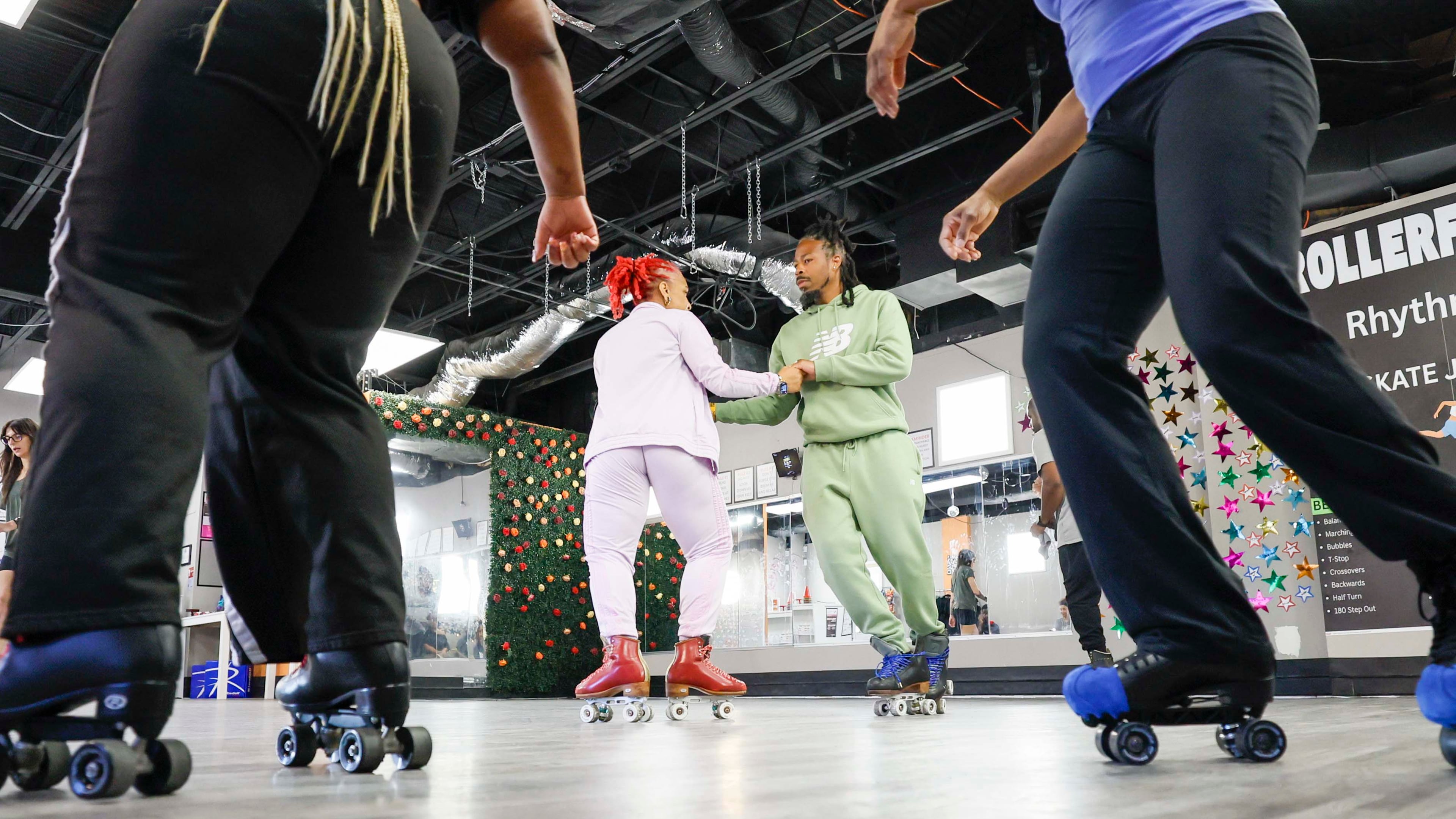 Instructors Lawrence Thomas and Gloria Downs, “Coach Glo,” work on a routine as intermediate students warm up during a boot camp class at the RollerFit studio in Atlanta on Sunday, Sept. 27, 2026. (Miguel Martinez/AJC)