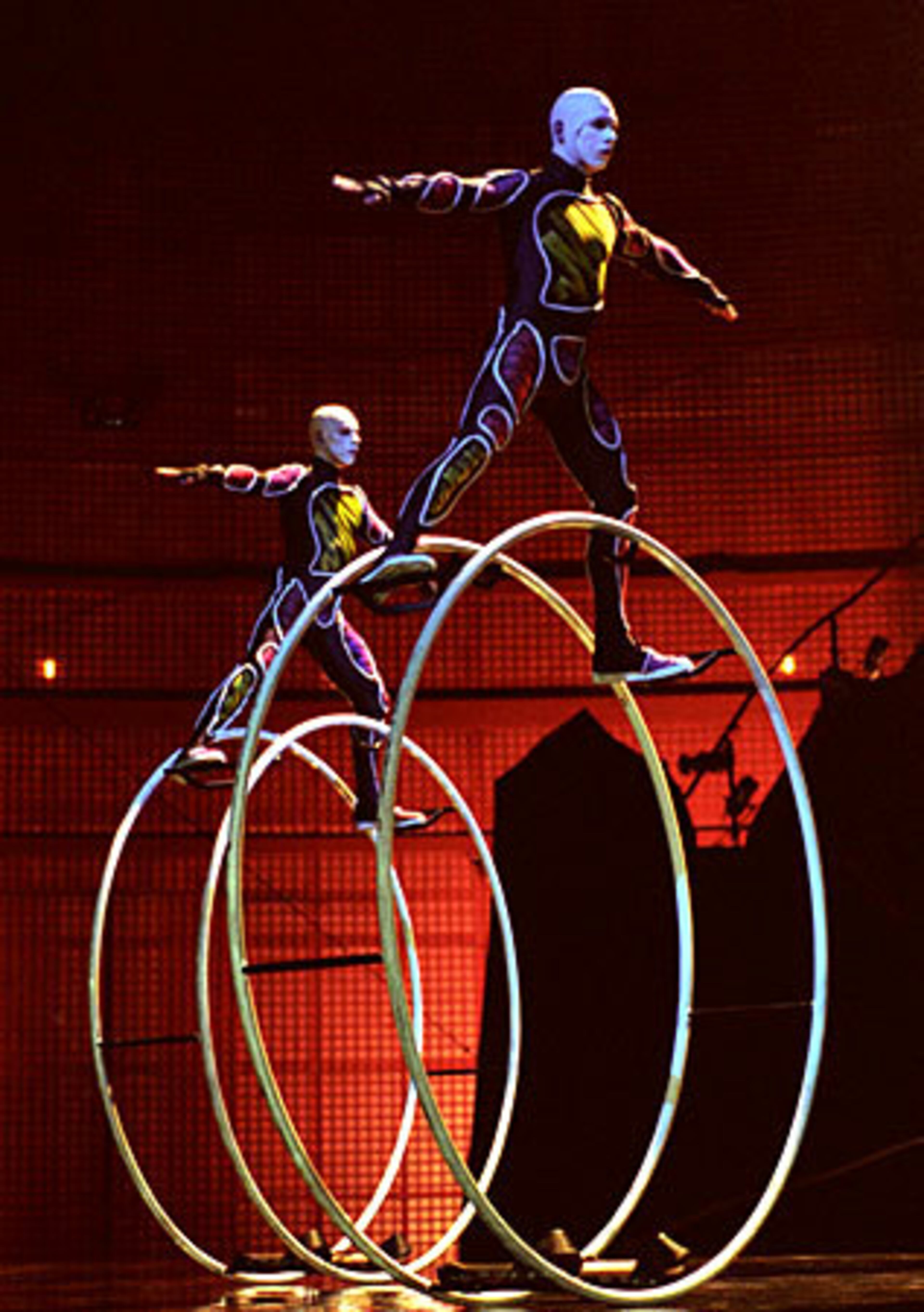 Identical twin brothers each spin a Roue allemande or German Wheel, performing in perfect synchronization in the spellbinding La Nouba, an original production of Cirque du Soleil at Walt Disney World Resort in Lake Buena Vista, Fla.