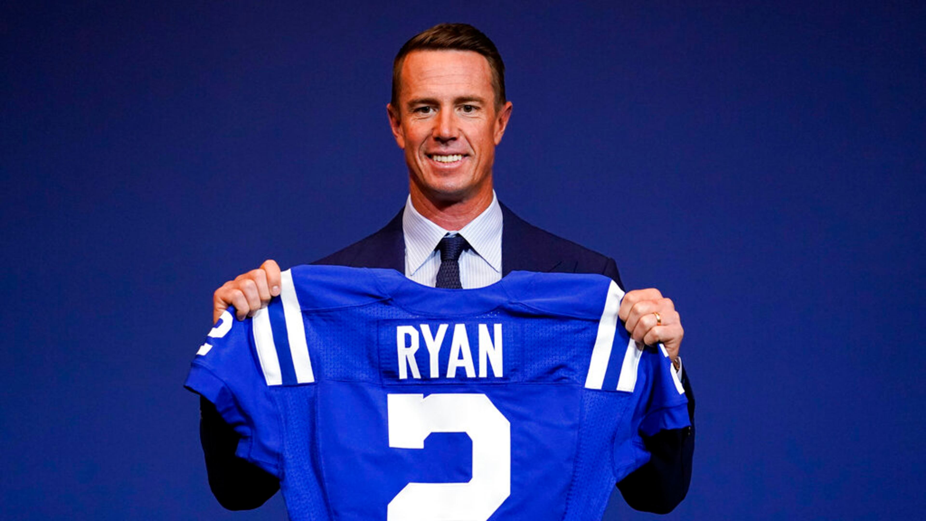 Indianapolis Colts quarterback Matt Ryan holds up his new jersey following a press conference at the NFL team's practice facility in Indianapolis on March 22, 2022. (AP Photo/Michael Conroy, File)