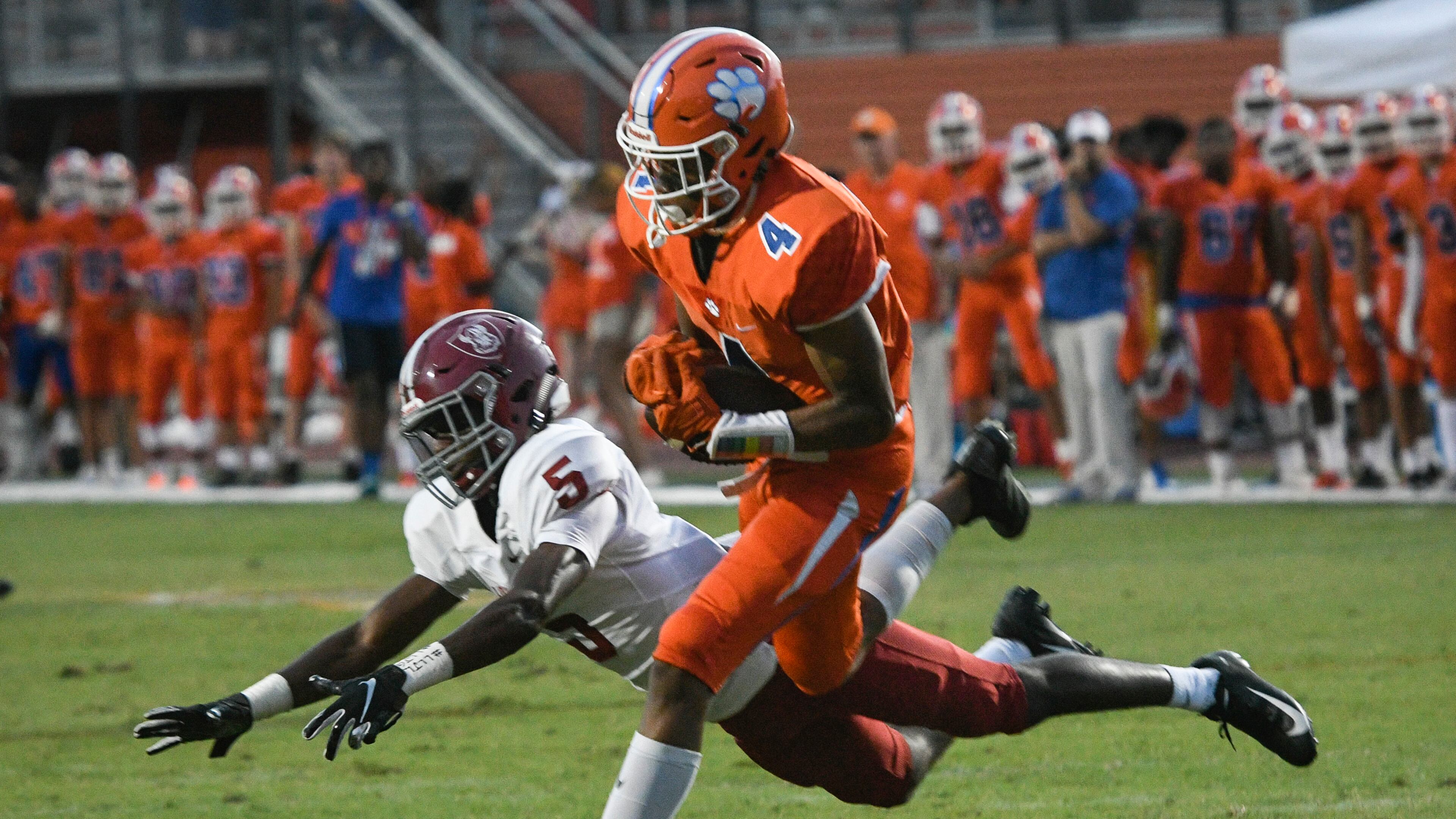 Parkview WR Cj Daniels (4) catches a pass as Lowndes CB Josh Brown defends before taking the ball in for a TD during a high school football game in Lilburn, Friday August 31, 2018. (John Amis/Special)