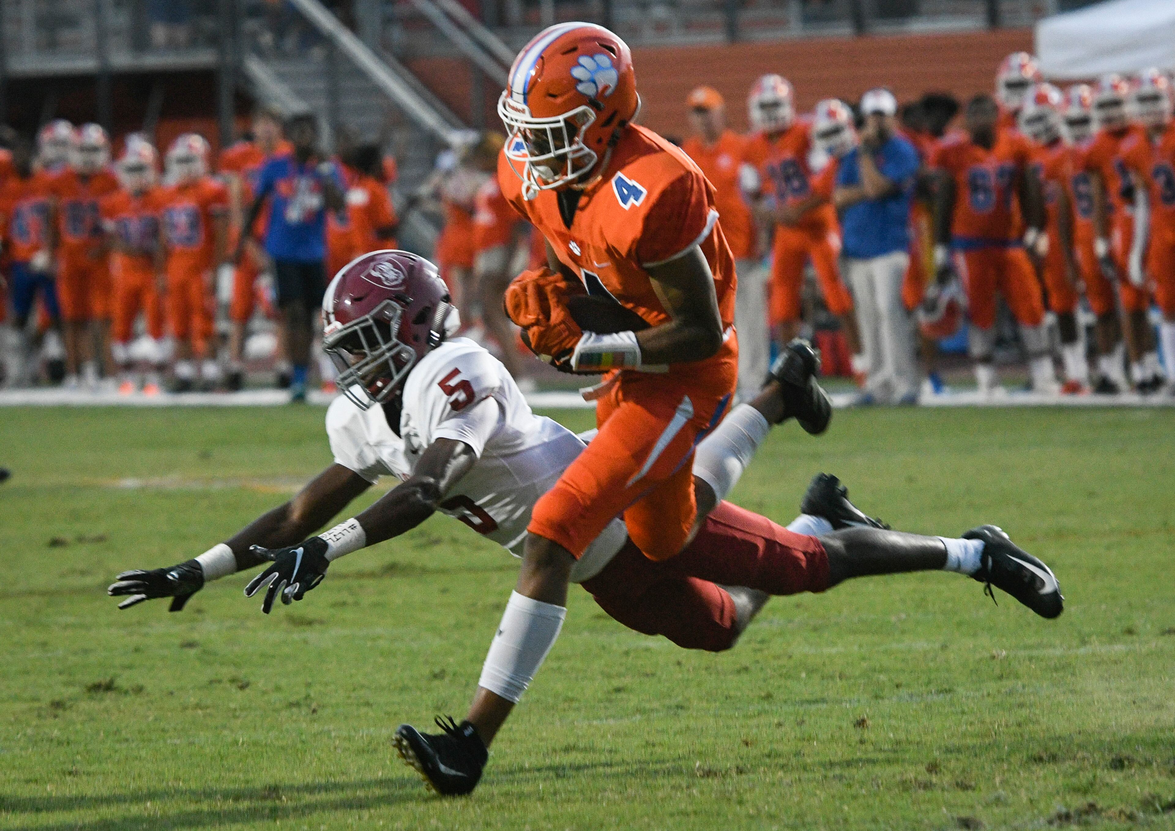 Parkview WR Cj Daniels (4) catches a pass as Lowndes CB Josh Brown defends before taking the ball in for a TD during a high school football game in Lilburn, Friday August 31, 2018. (John Amis/Special)