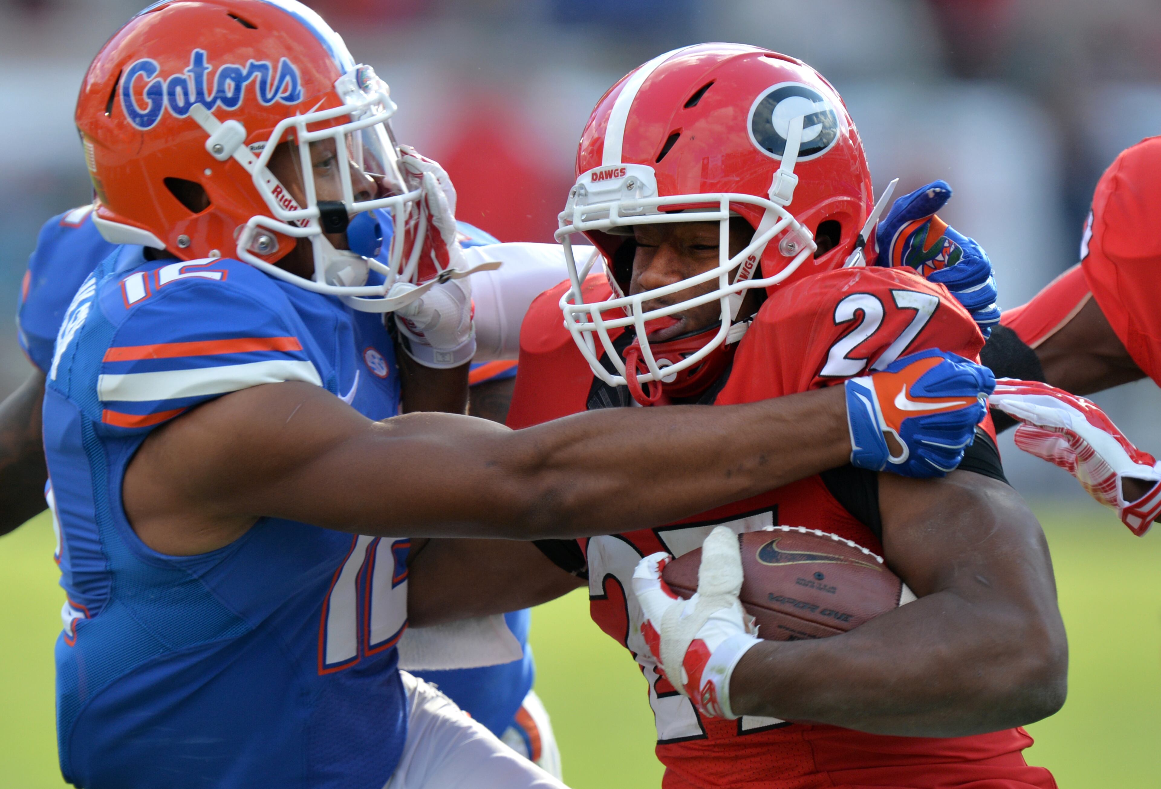 Georgia Bulldogs running back Nick Chubb is brought down by Florida Gators defensive back Quincy Wilson during the first half in Jacksonville Saturday November 1, 2014. BRANT SANDERLIN / BSANDERLIN@AJC.COM