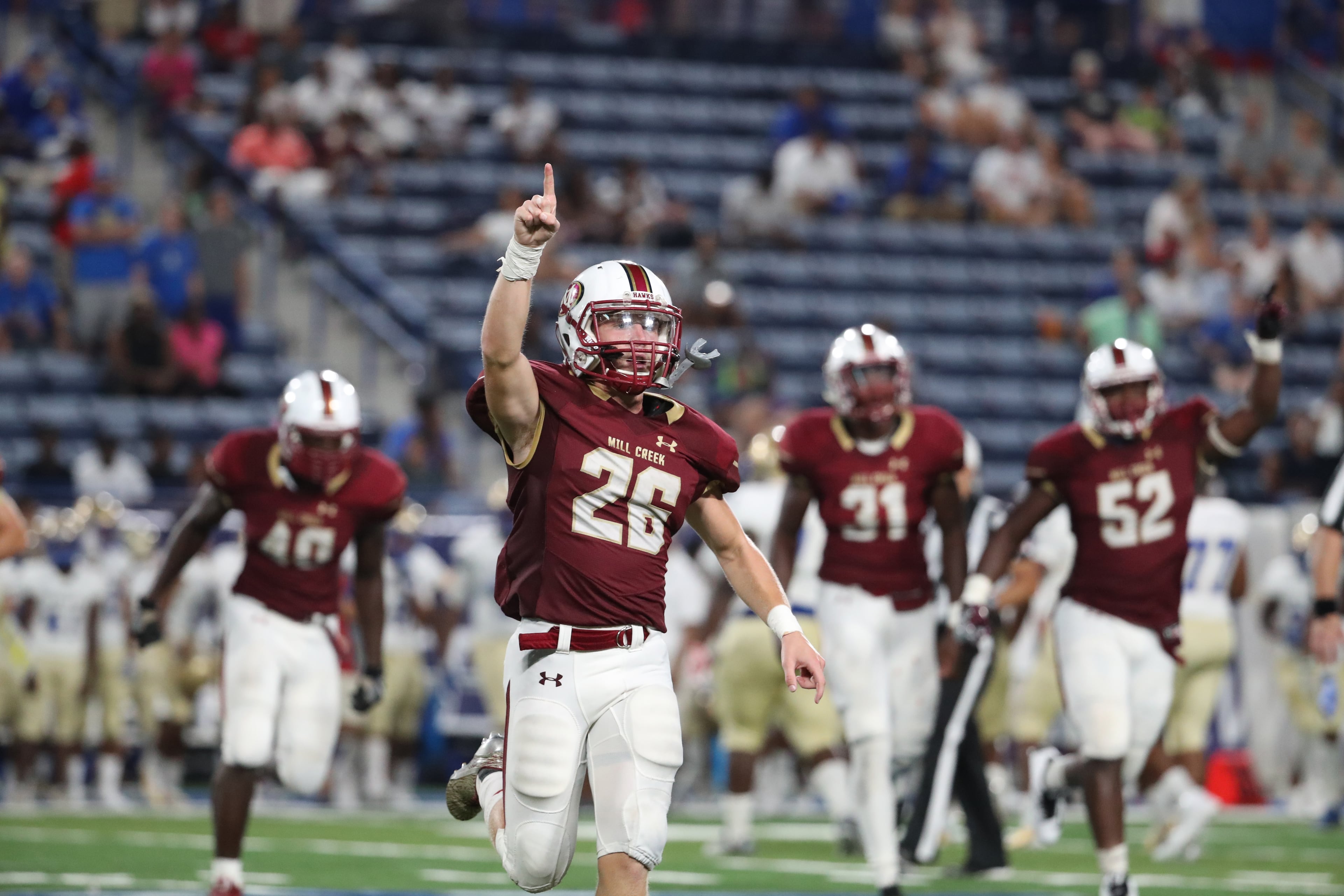 Mill Creek defensive back Jacob Allen (26) celebrates a defensive stop in the second half of their game against McEachern during the Corky Kell Classic at Georgia State Stadium Saturday, August 19, 2017, in Atlanta. Mill Creek won 23-19.