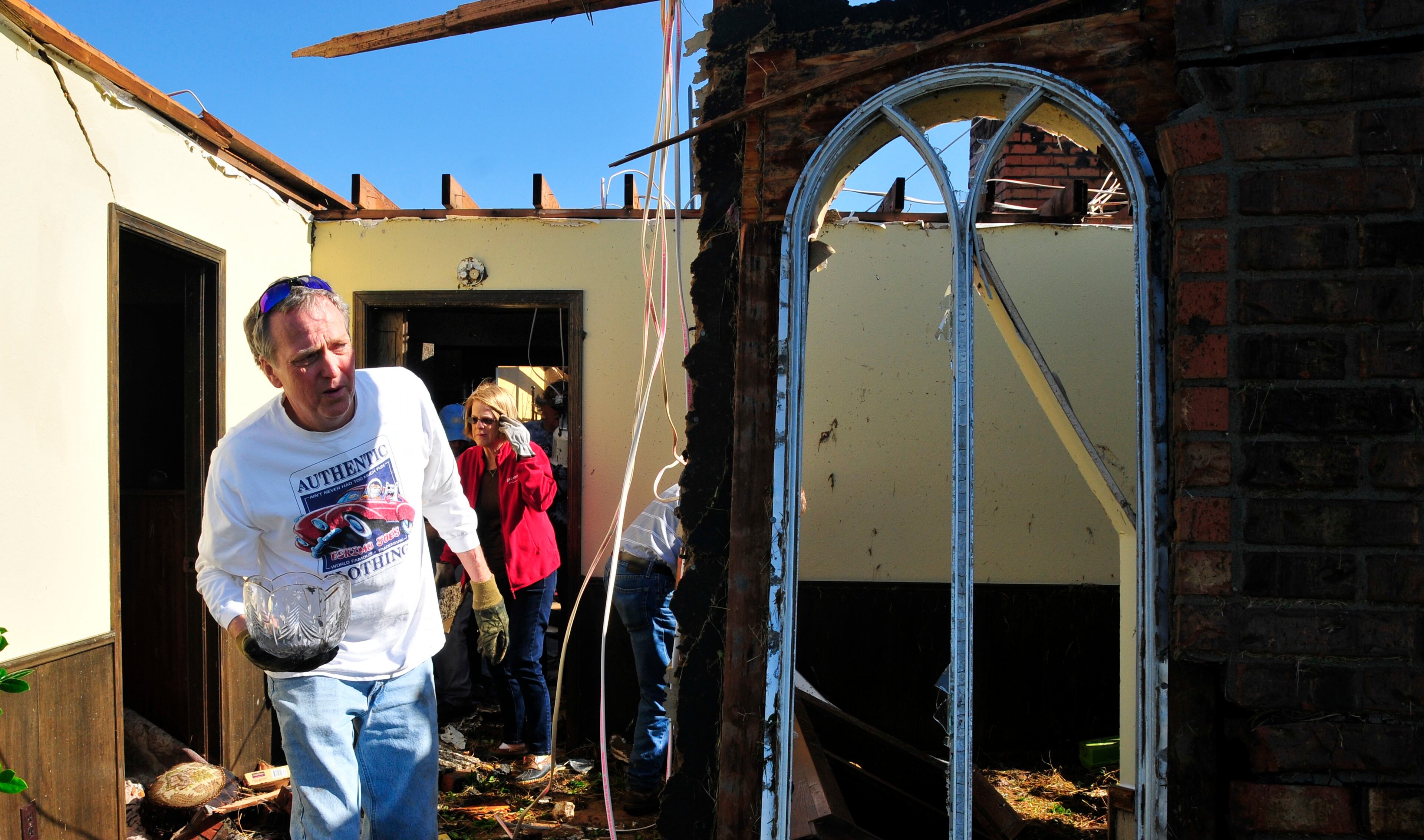 Greg Hulett, left, and Ruth Magers, right, help their friend Bobbie Steenbergen recover what's left from her home that was destroyed by the tornado's that swept through Central Oklahoma Friday afternoon on Saturday June 1, 2013 in El Reno Okla. (AP Photo/Nick Oxford)