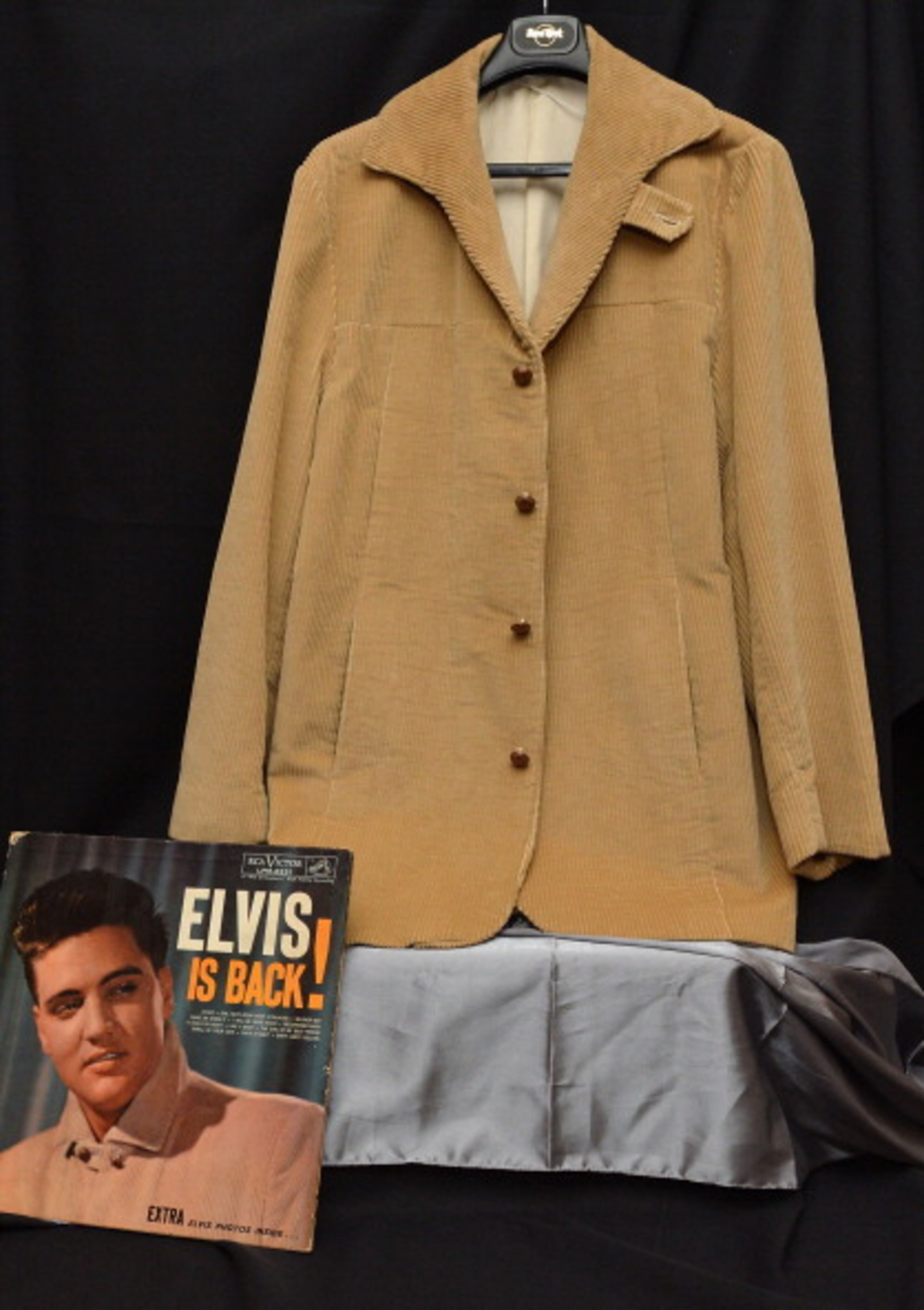 NEW YORK, NY - DECEMBER 03: Elvis Presley's 1960 "Elvis is Back" album cover worn tan corduroy jacket on display at "Icons & Idols: Rock n' Roll" on December 3, 2013 in New York City. (Photo by Slaven Vlasic/Getty Images)