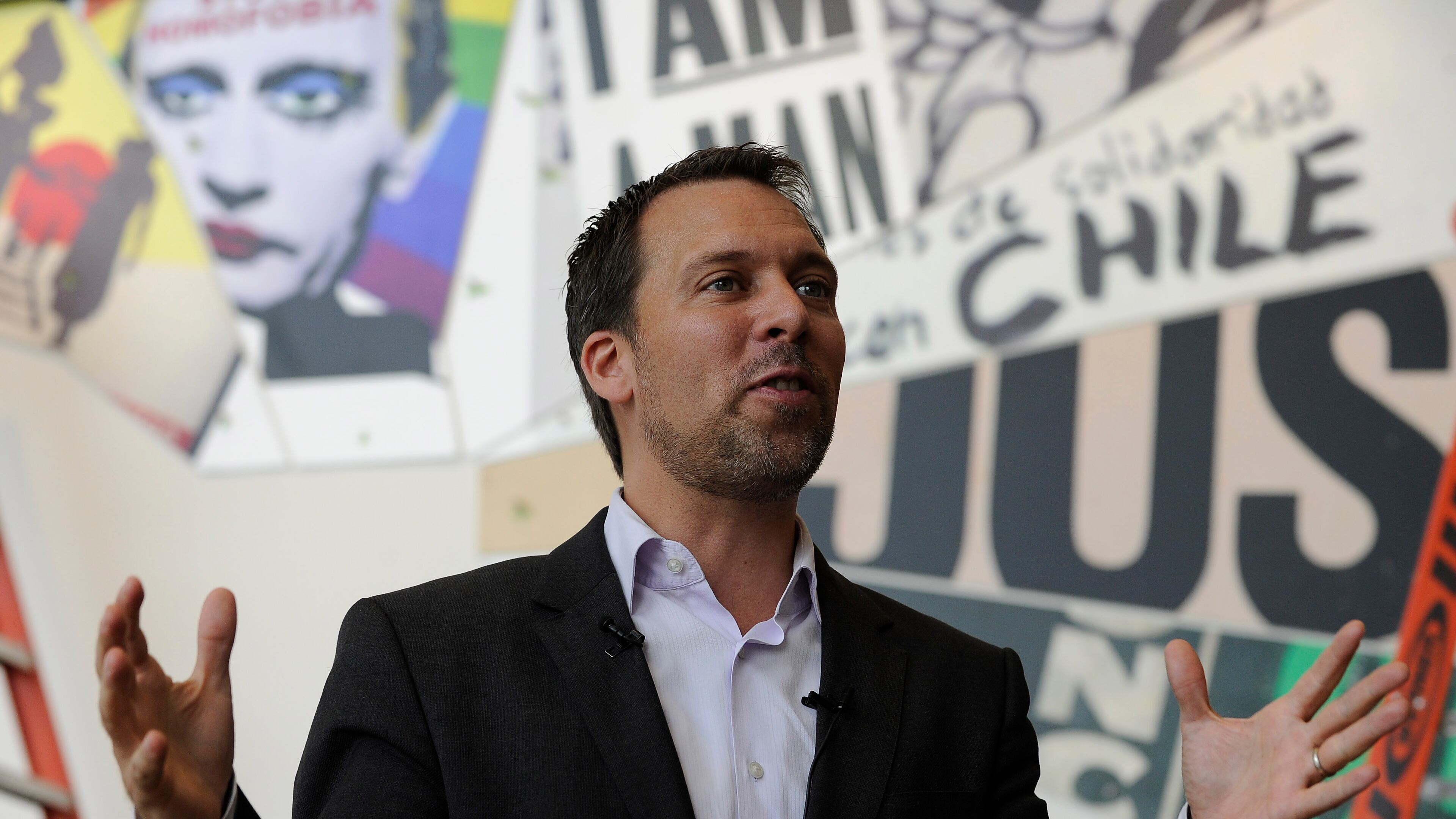 National Center for Civil and Human Rights CEO Doug Shipman explains exhibits during a walk-through for the new facility Tuesday, June 10, 2014, in Atlanta. The main exhibits include: the King papers on the first floor, the second floor main entrance, open space and mural, the lunch counter, interactive TV displays, Freedom Rider Bus, and stained glass portraits of four girls killed during violence in Alabama, while the third floor showcases the global human rights footprint with intimate cone-shaped movie theaters and a villains and champions exhibit. David Tulis / AJC Special