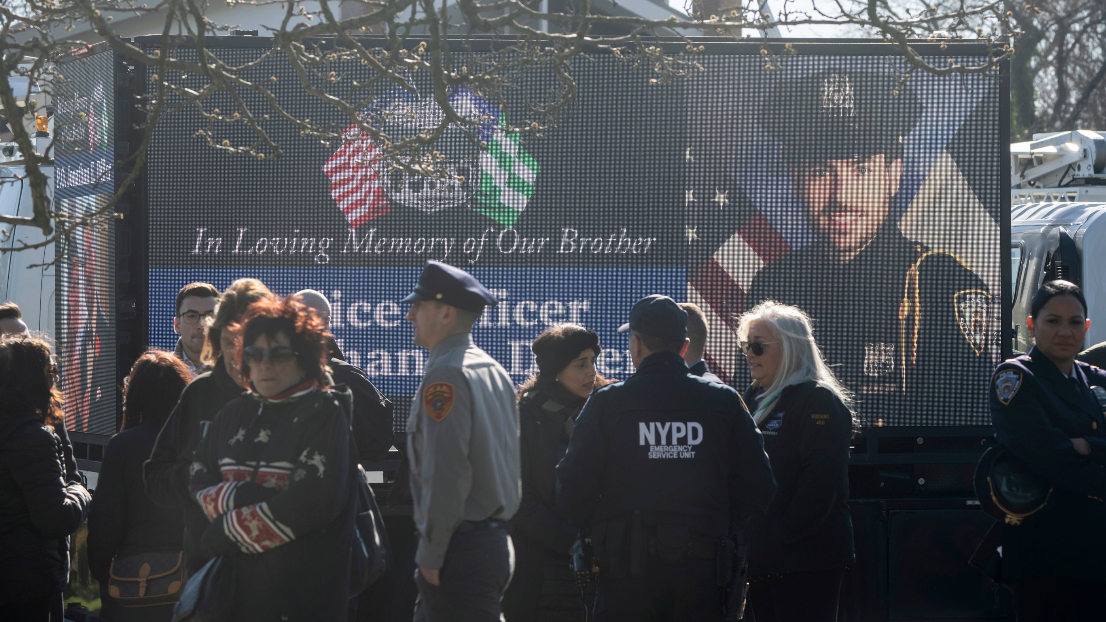 FILE - New York Police Department Officer Jonathan Diller is on a screen during his funeral service at Saint Rose of Lima R.C. Church in Massapequa Park, N.Y., March 30, 2024. (AP Photo/Jeenah Moon, File)