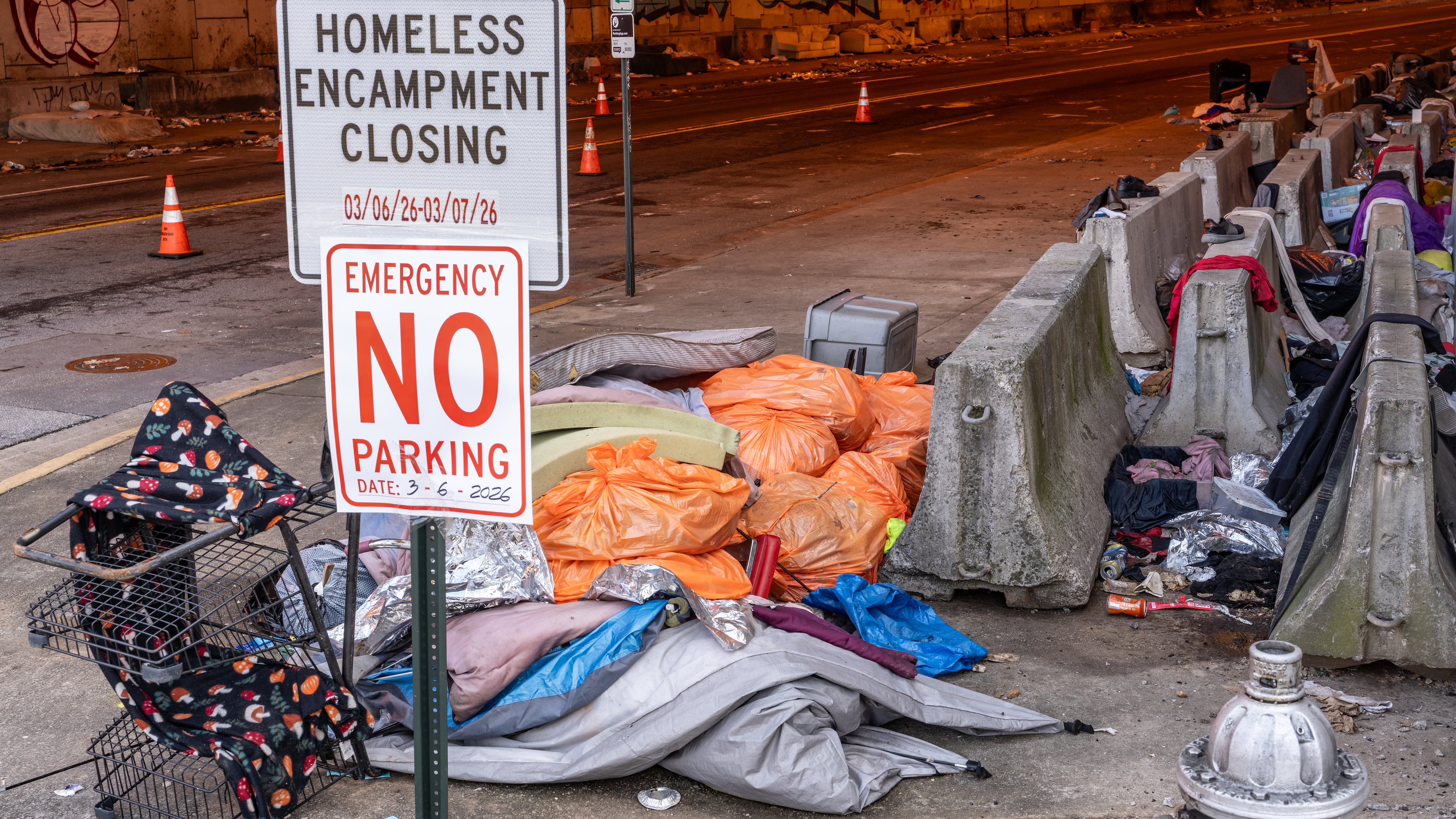 Trash is seen littered around a homeless encampment that runs along Leonard Tate Street under I-85 in downtown Atlanta. In recent years, homelessness policy in some of Georgia’s largest cities has drifted toward selective enforcement, guest columnist Victor Riches writes. (Ben Hendren for the AJC)