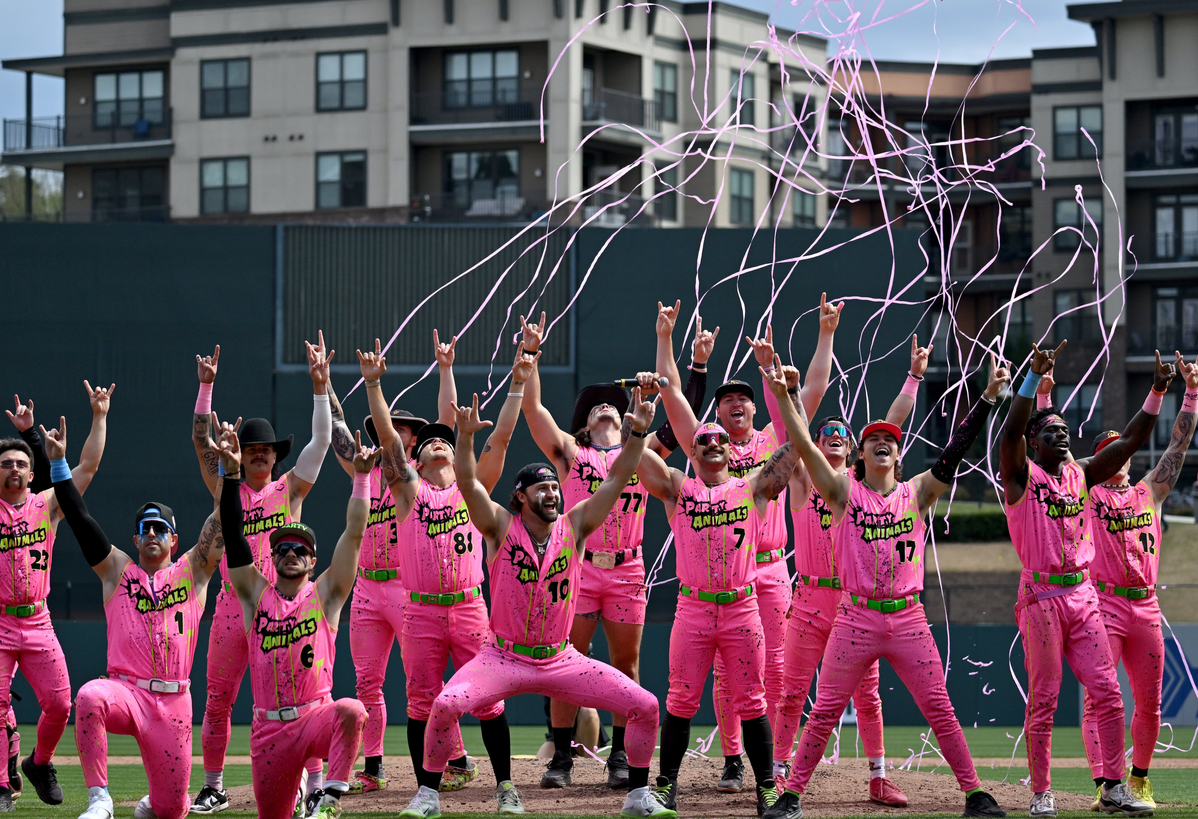 Party Animals players celebrate their win over the Savannah Bananas during the first game of three-game series at Coolray Field. (Hyosub Shin / Hyosub.Shin@ajc.com)