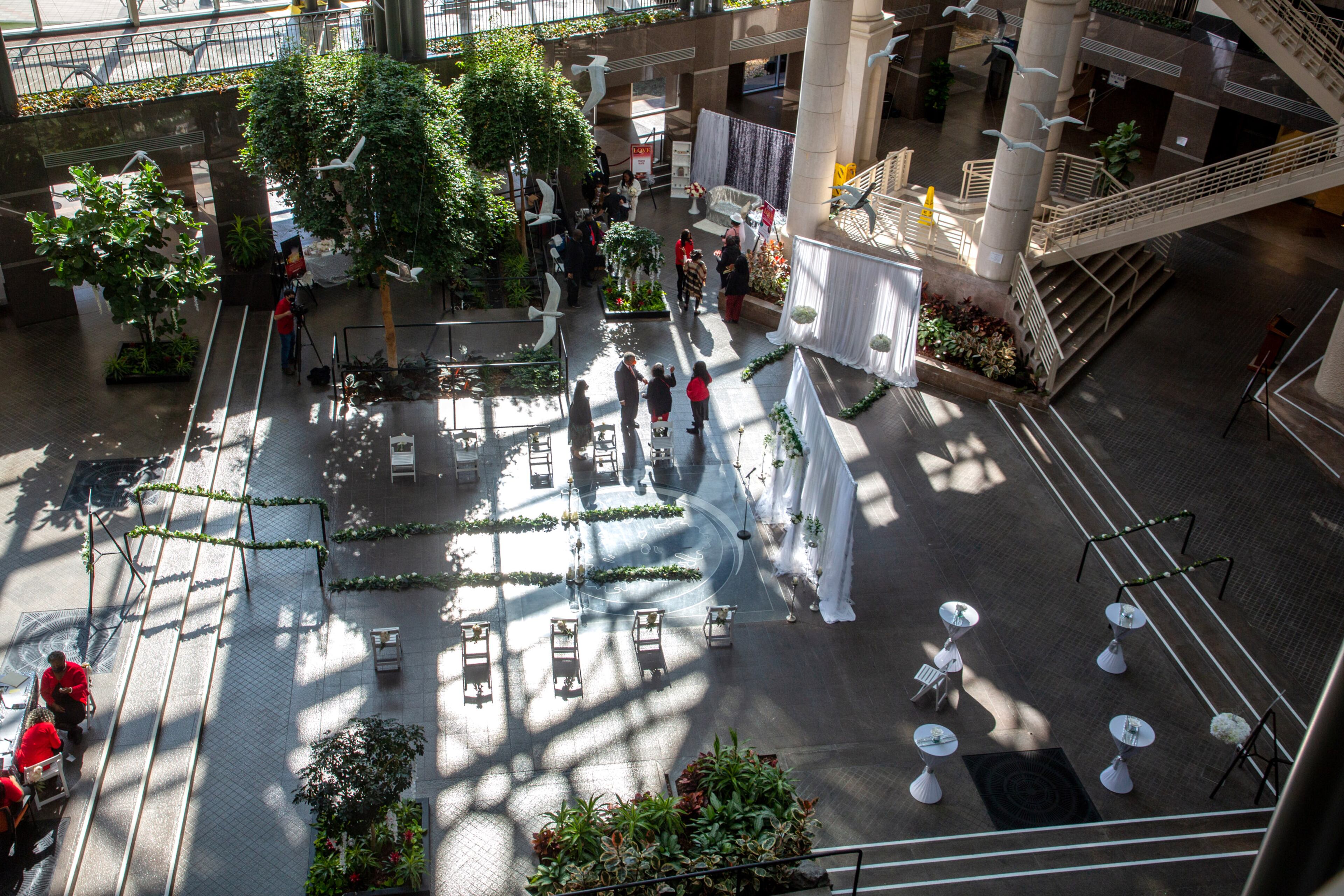 People stand around and wait for the next wedding ceremony to start in the Atrium of the Fulton County Gov. Bldg. on valentines day, February 14, 2022. STEVE SCHAEFER FOR THE ATLANTA JOURNAL-CONSTITUTION