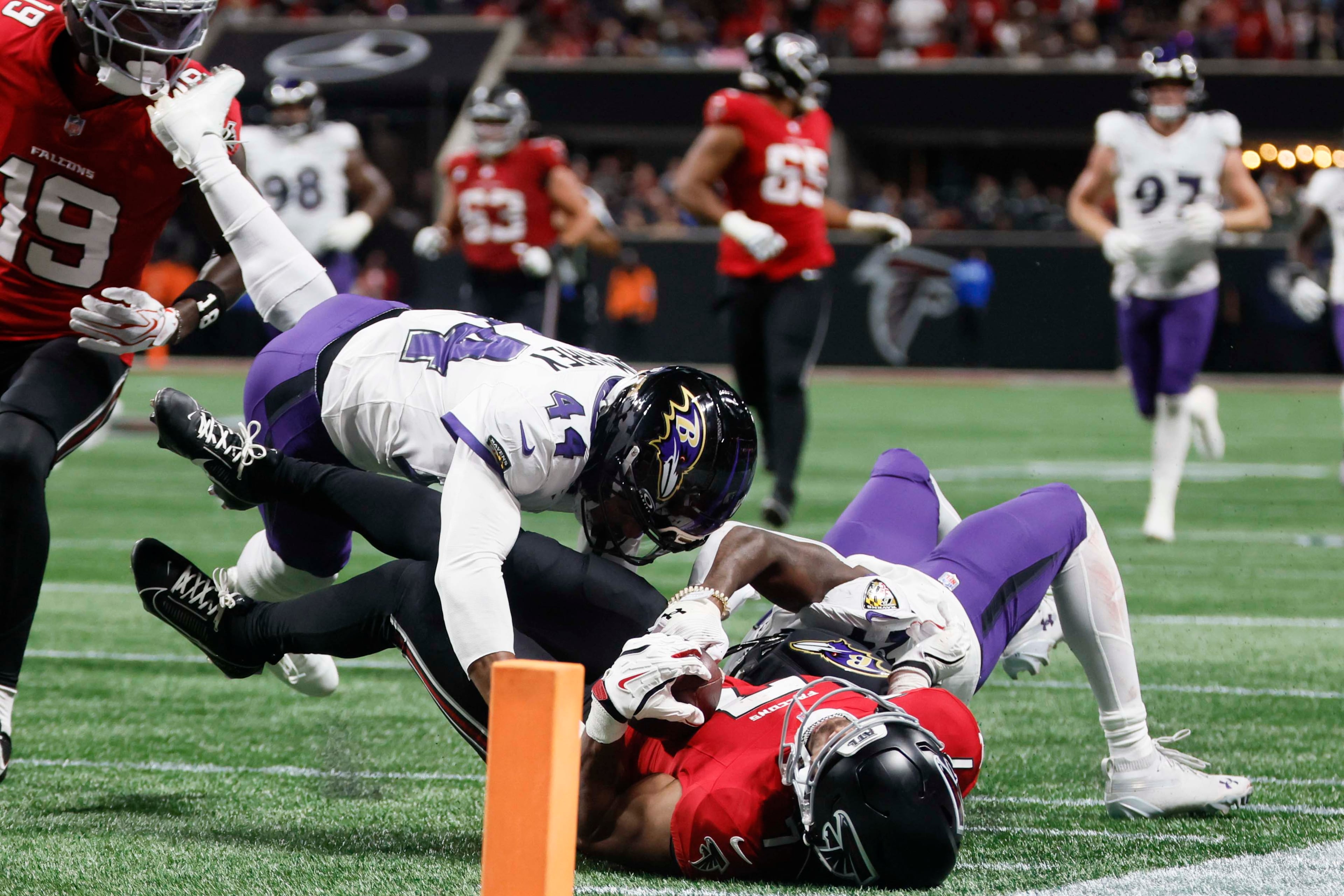 Baltimore Ravens cornerback Marlon Humphrey (44) and teammate stopped Atlanta Falcons running back Bijan Robinson (7) before Robinson reached the end zone during the second half of a football game against the Baltimore Ravens at Mercedes-Benz Stadium in Atlanta, GA, Sunday, Oct. 11, 2026. (Miguel Martinez/AJC)