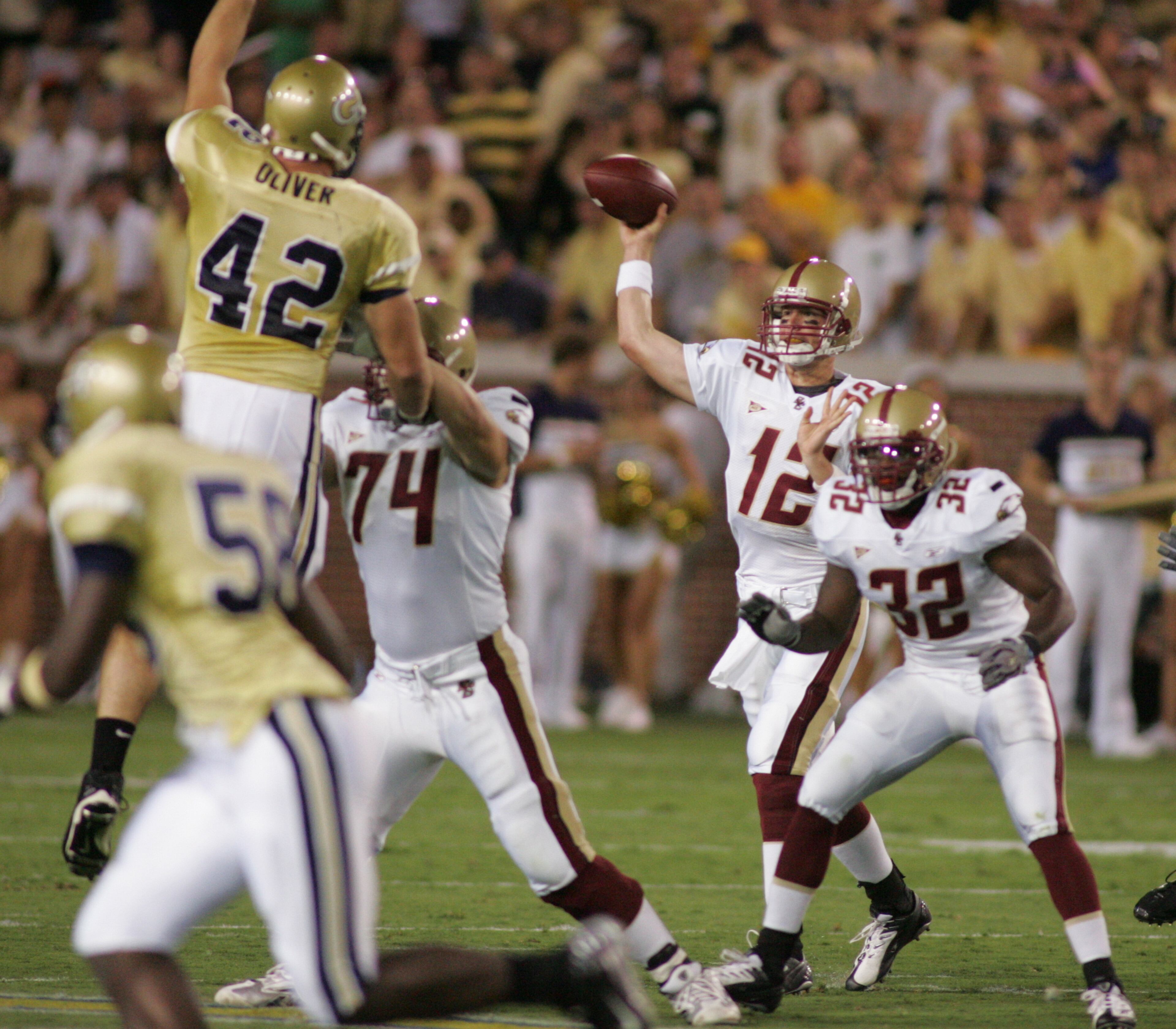 20070915 - Atlanta - Boston College at Georgia Tech football. Matt Ryan (12) get's a pass off despite pressure from tech Adamm Oliver (42). BOB ANDRES/STAFF