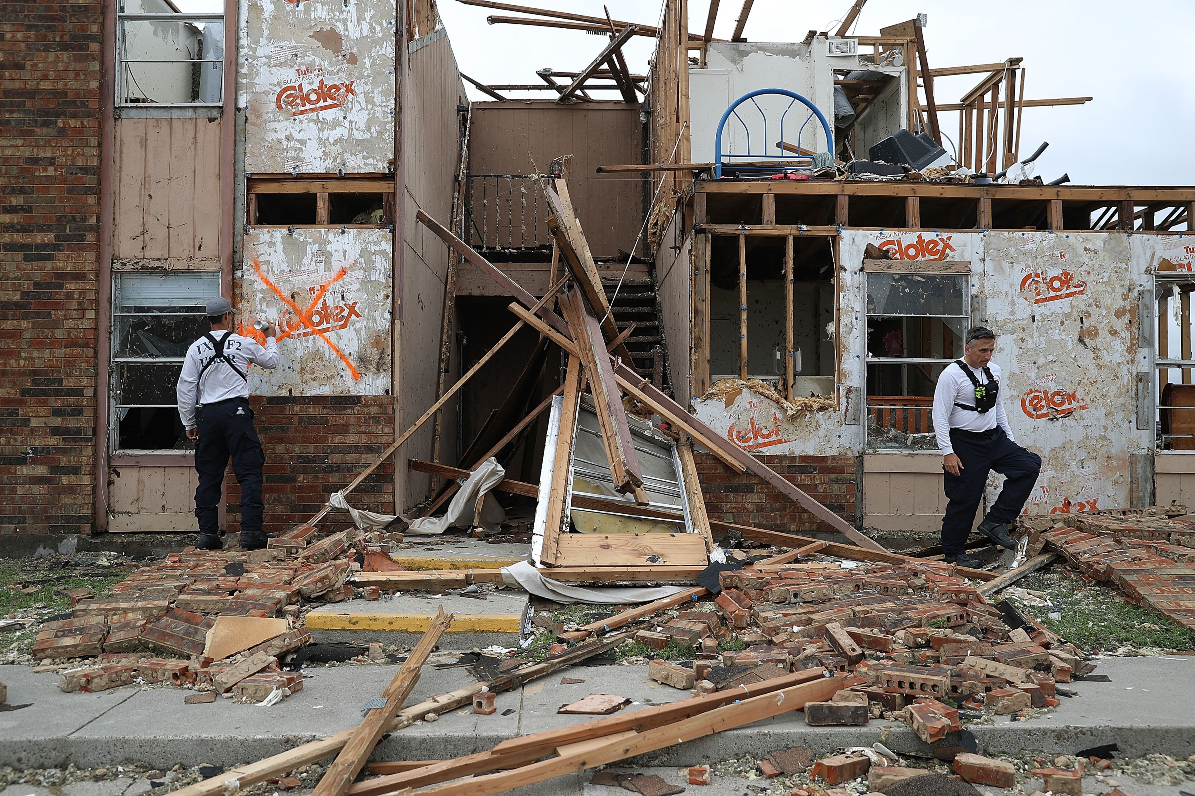 ROCKPORT, TX - AUGUST 26: Members of the Texas Task Force 2 search and rescue team work through a destroyed apartment complex trying to find anyone that still may be in the apartment complex after Hurricane Harvey passed through on August 27, 2017 in Rockport, Texas. Harvey made landfall shortly after 11 p.m. Friday, just north of Port Aransas as a Category 4 storm and is being reported as the strongest hurricane to hit the United States since Wilma in 2005. Forecasts call for as much as 30 inches of rain to fall in the next few days. (Photo by Joe Raedle/Getty Images)