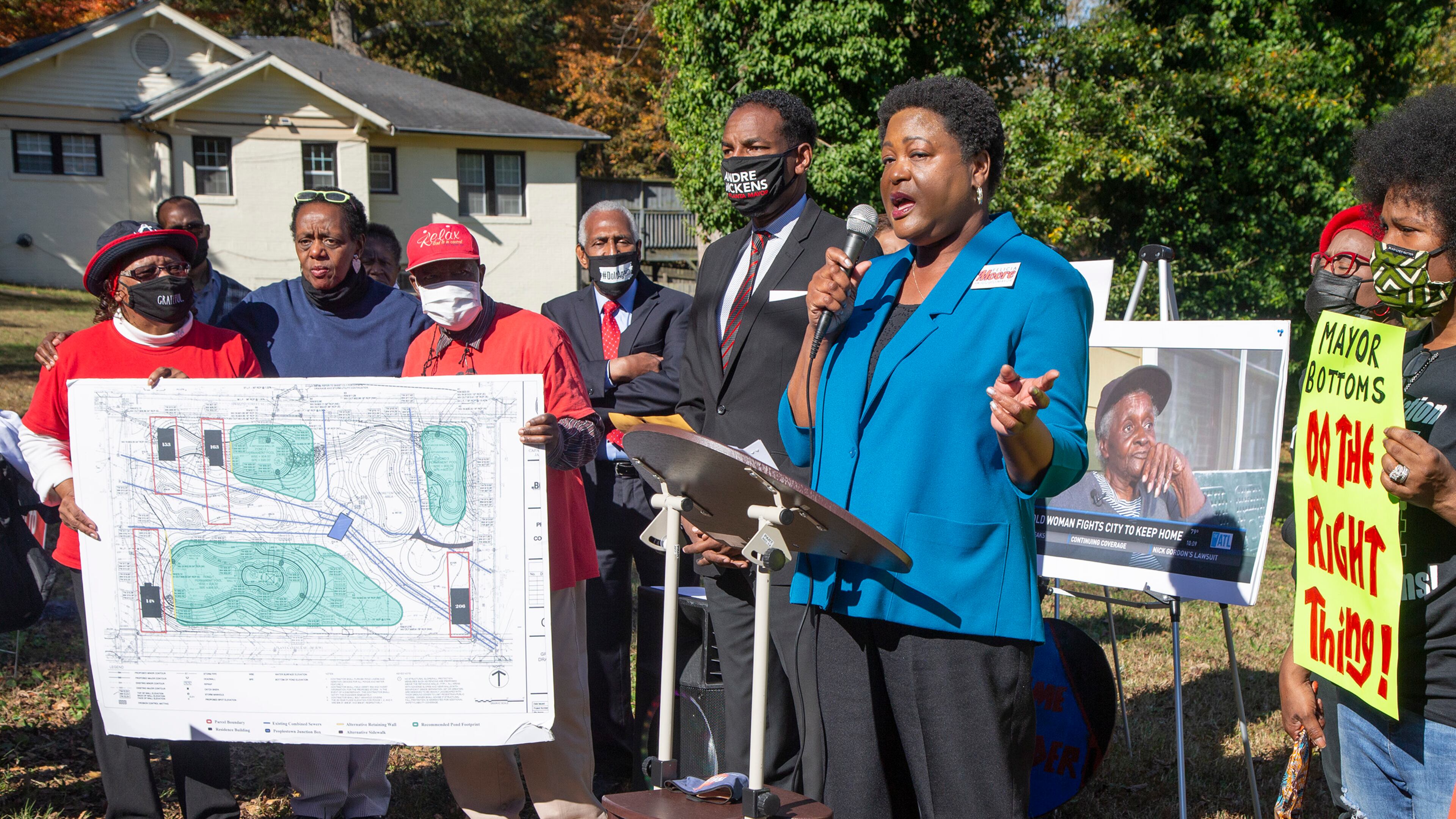 Andre Dickens (center) listens as Feilcia Moore speaks during an Anti-Election rally where Peoplestown residents are fighting the city of AtlantaÕs year long attempt to take away their homes. The city is trying to do so in order to improve the flood protection conditions in Peoplestown. The two mayoral runoff candidates say they support the people but one of them will ultimately be on the opposing side come January. PHIL SKINNER FOR THE ATANTA JOURNAL-CONSTITUTION