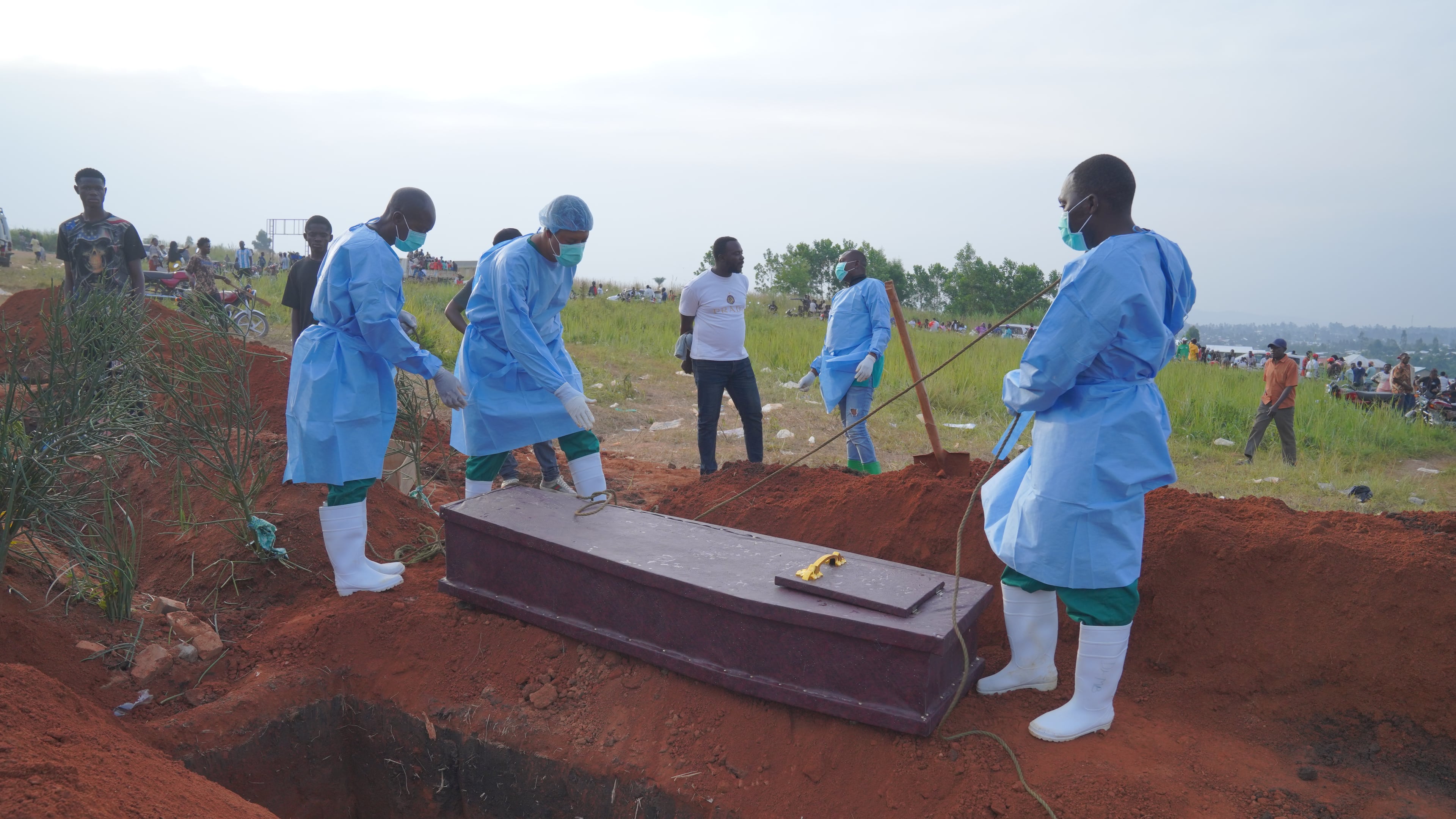 FILE - People dressed in protective gear prepare to lower into a grave the coffin containing the remains of six-year-old Baudjo Baraka Jules, who died of Ebola, in Bunia, Ituri province, eastern Congo, on Aug. 18, 2026. (AP Photo/Dieudonne Dirole, File)