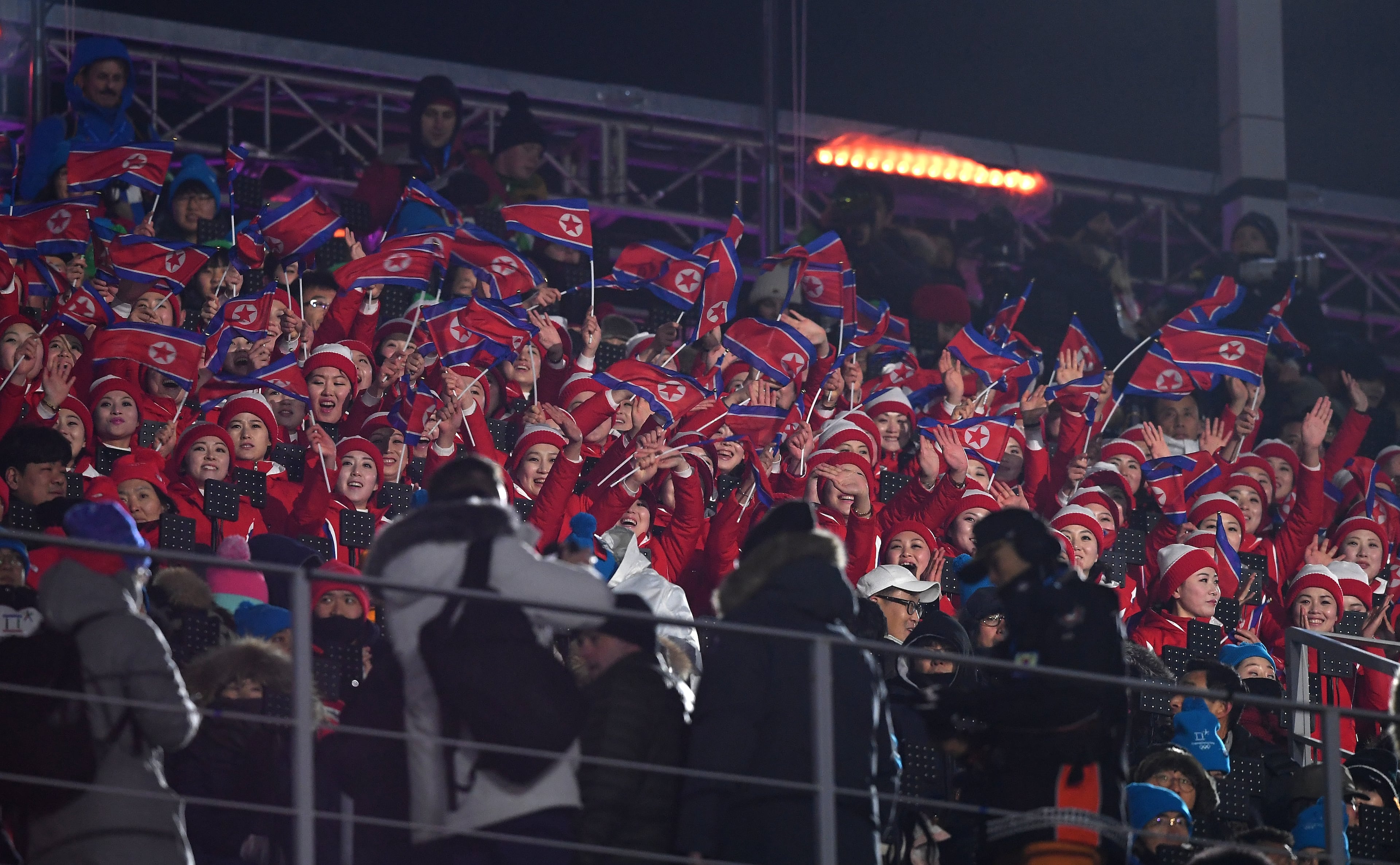 PYEONGCHANG-GUN, SOUTH KOREA - FEBRUARY 09: North Korean spectators attend the Opening Ceremony of the PyeongChang 2018 Winter Olympic Games at PyeongChang Olympic Stadium on February 9, 2018 in Pyeongchang-gun, South Korea. (Photo by Quinn Rooney/Getty Images)