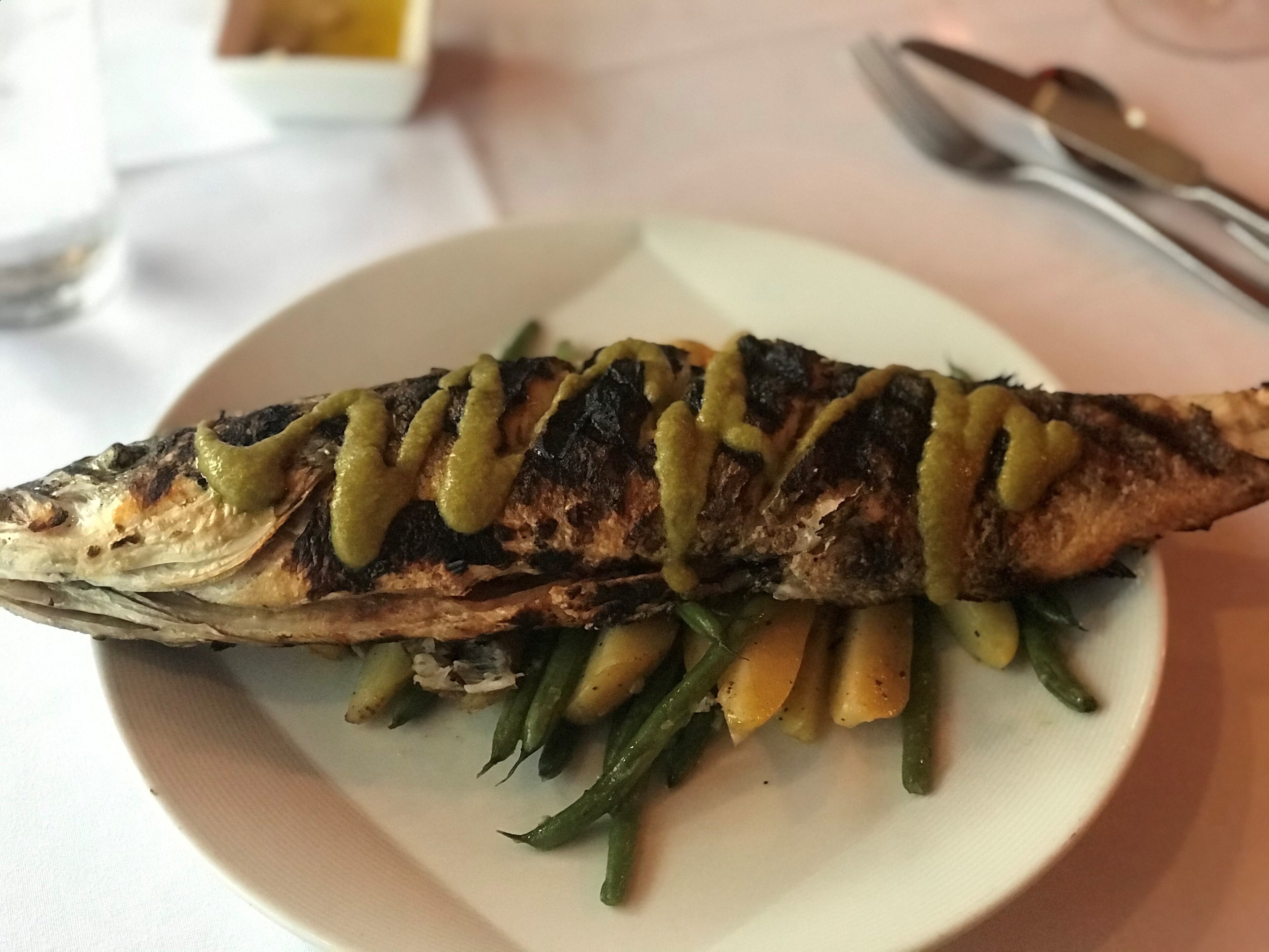 The Branzino di Salo from Piastra in Marietta is a whole grilled Mediterranean sea bass with fingerling potatoes and green beans, topped with a sauce of parsley, lemon and pepperoncini.
