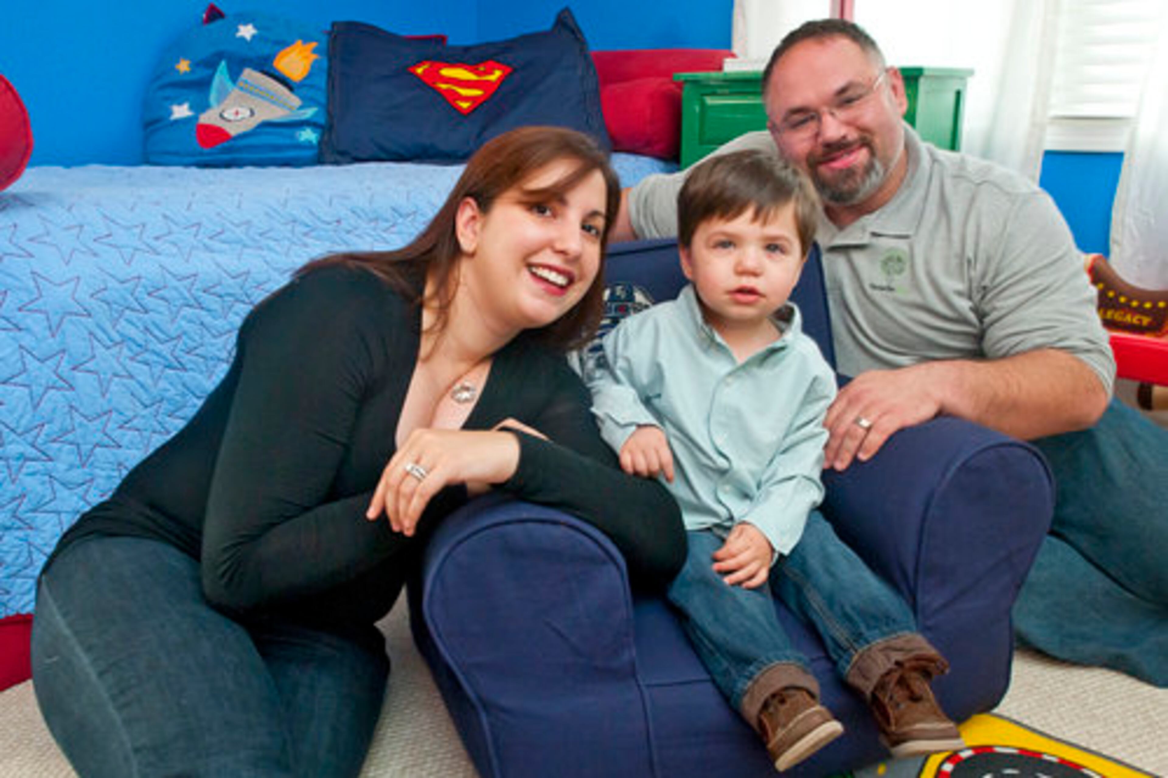 Vanessa and Jason Shapiro relax with their son Jake,16 months, in the playroom of their Dunwoody house.